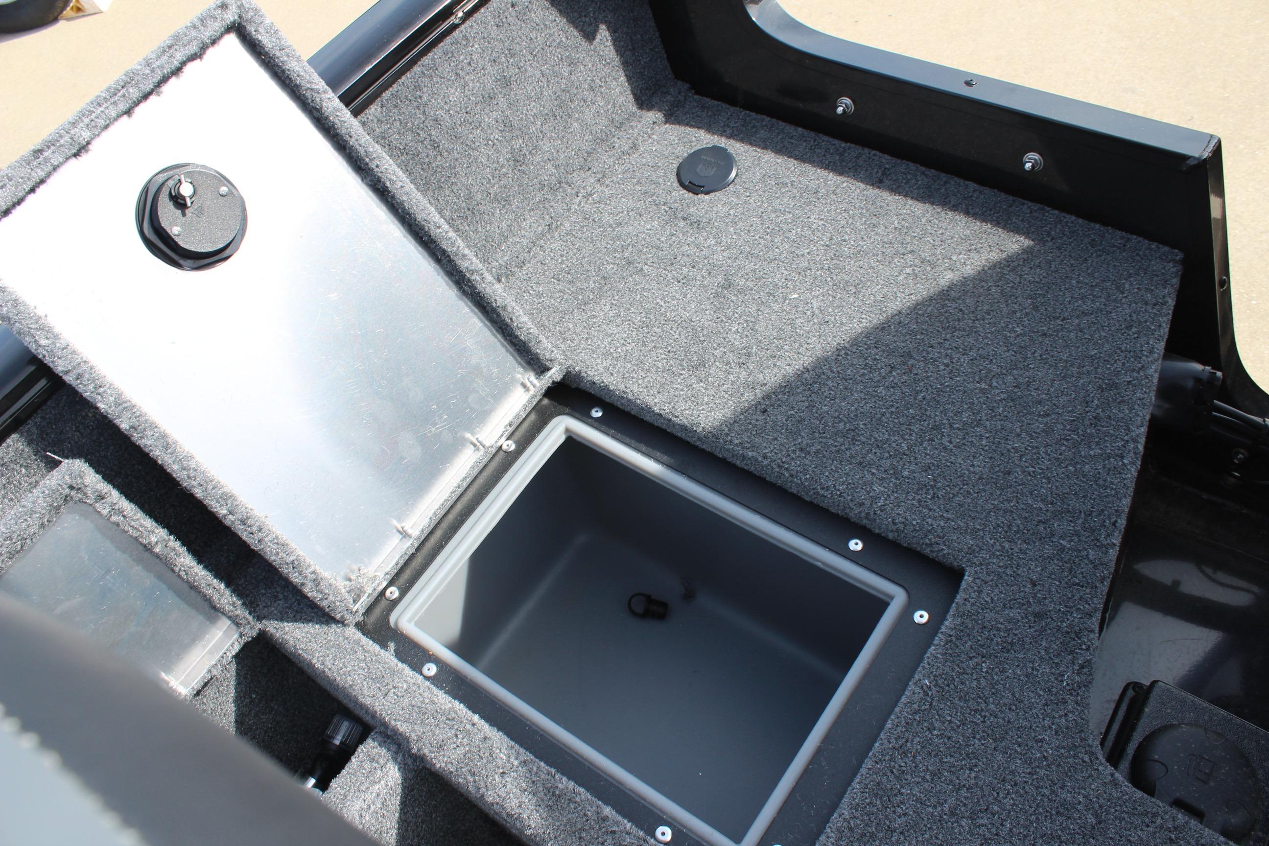 2026 Tracker Pro Guide V-16 WT boat storage compartment with carpeted interior.