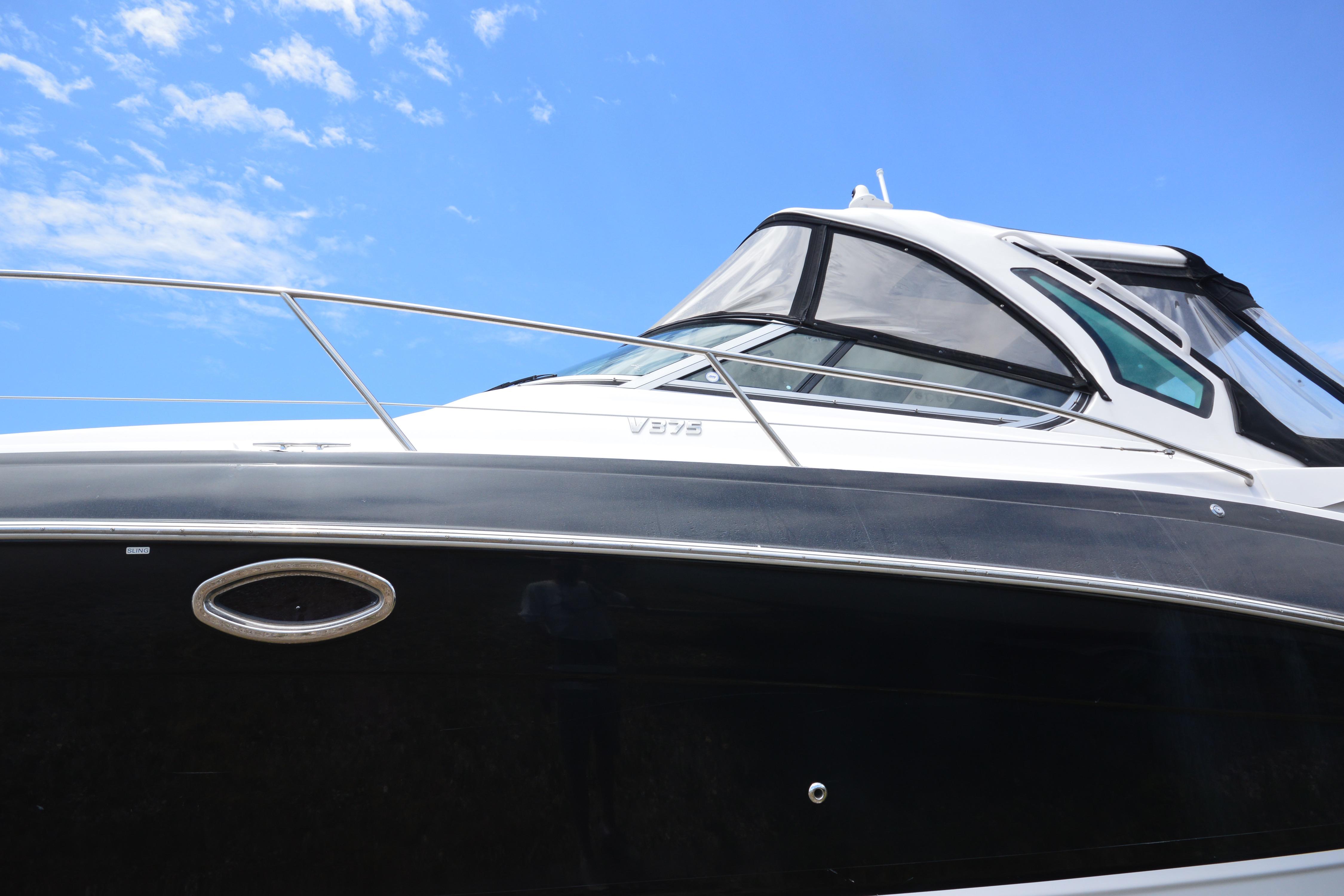 2013 Four Winns V375 boat against a clear blue sky.