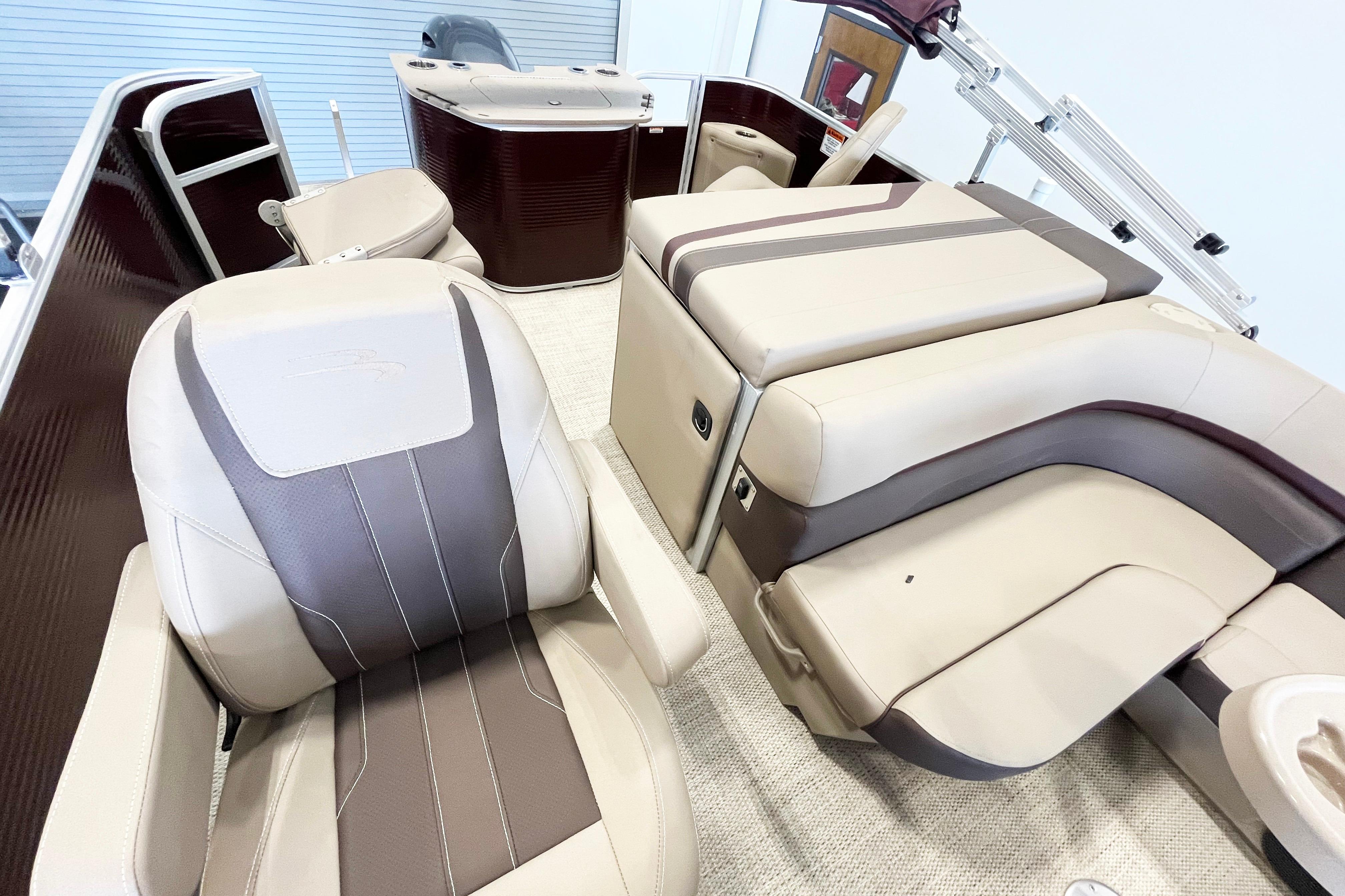 2020 Bennington SX25 boat interior with beige and brown seating, showcasing luxury and comfort.