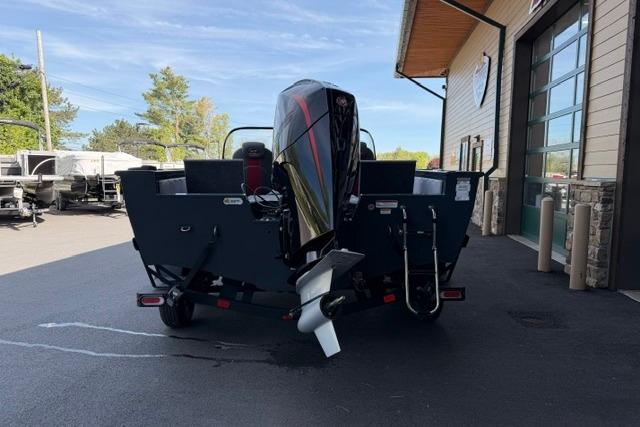 Ranger VX1988 WT 2026 boat with outboard motor, parked outside a building.