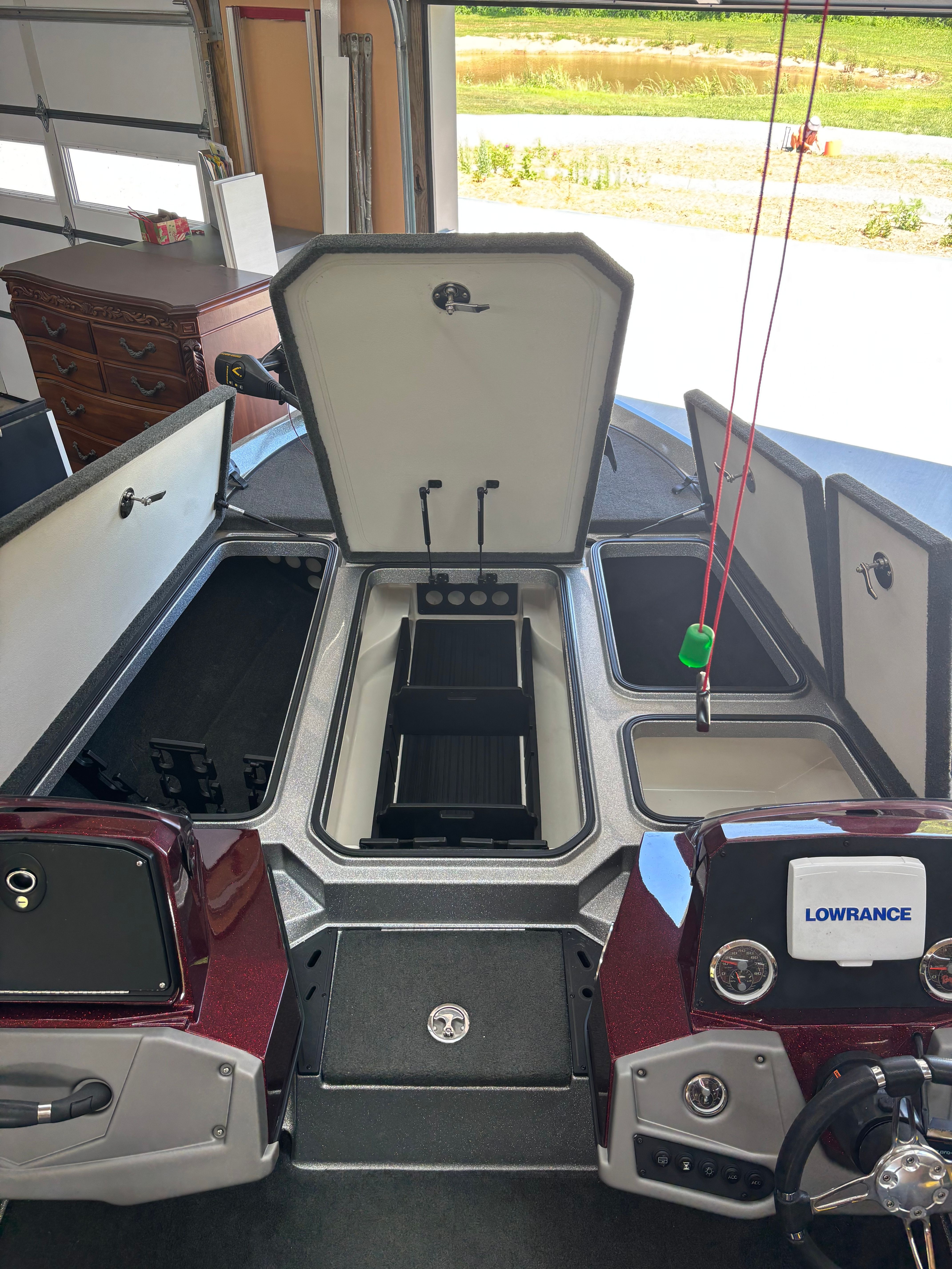 The image shows a Ranger Z 185 boat in a garage with open storage compartments.
