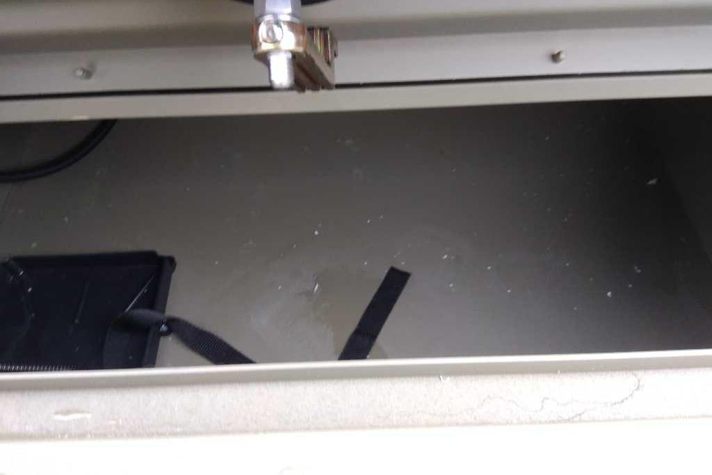 Storage compartment of 2026 Tracker Grizzly 1754 SC boat, featuring a latch and strap.