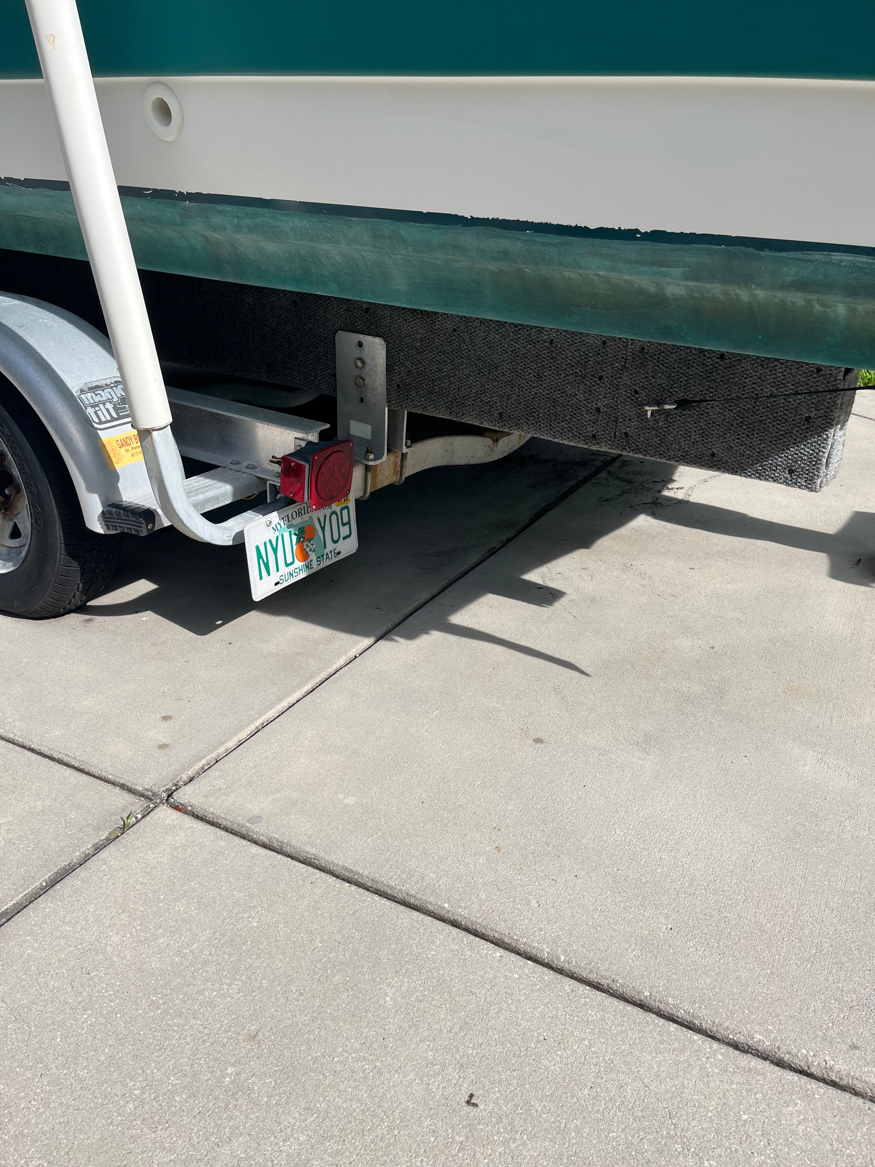 1993 Hurricane Fun Deck boat on trailer with license plate.
