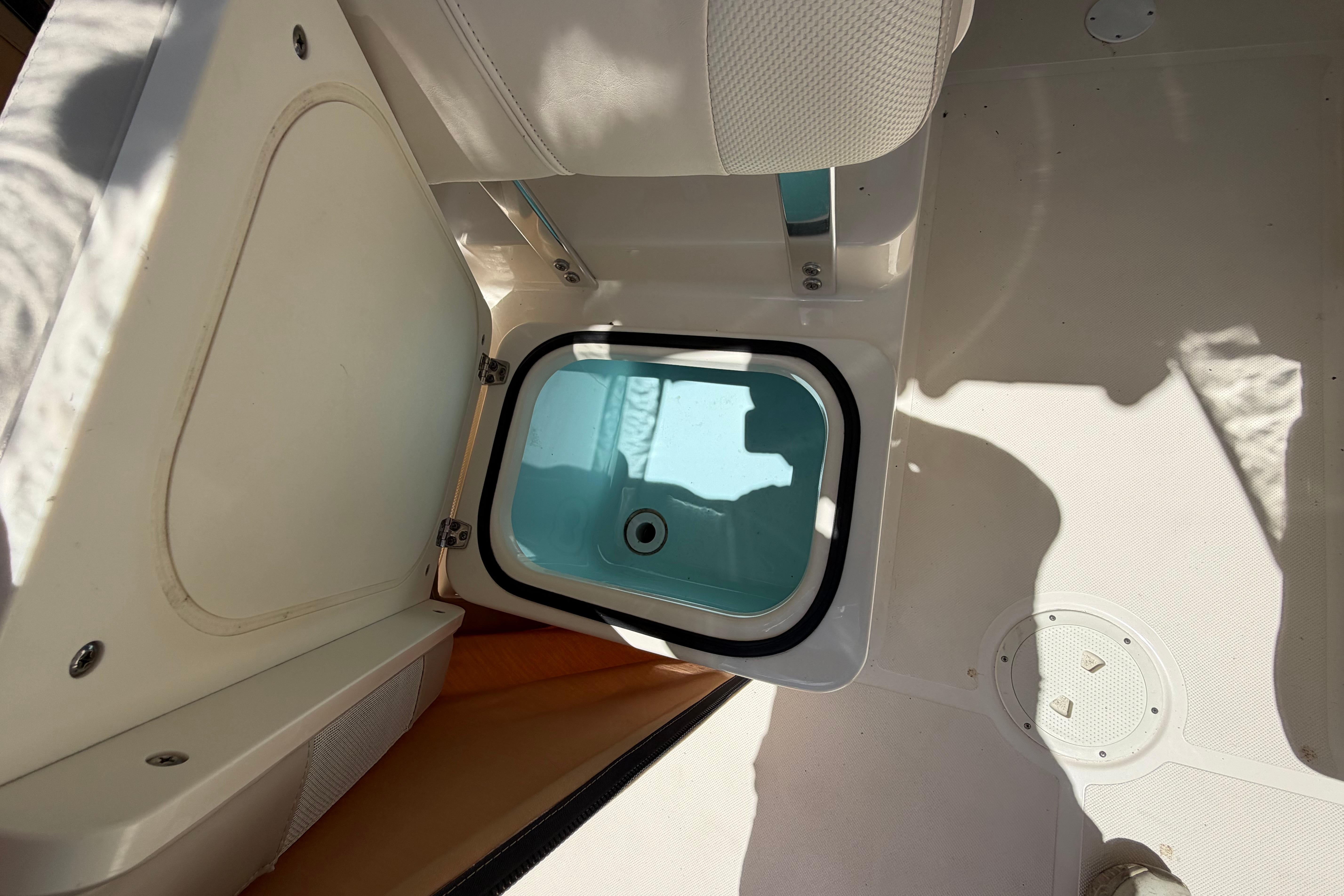 2010 Pursuit OS 255 Offshore boat interior with open storage compartment.