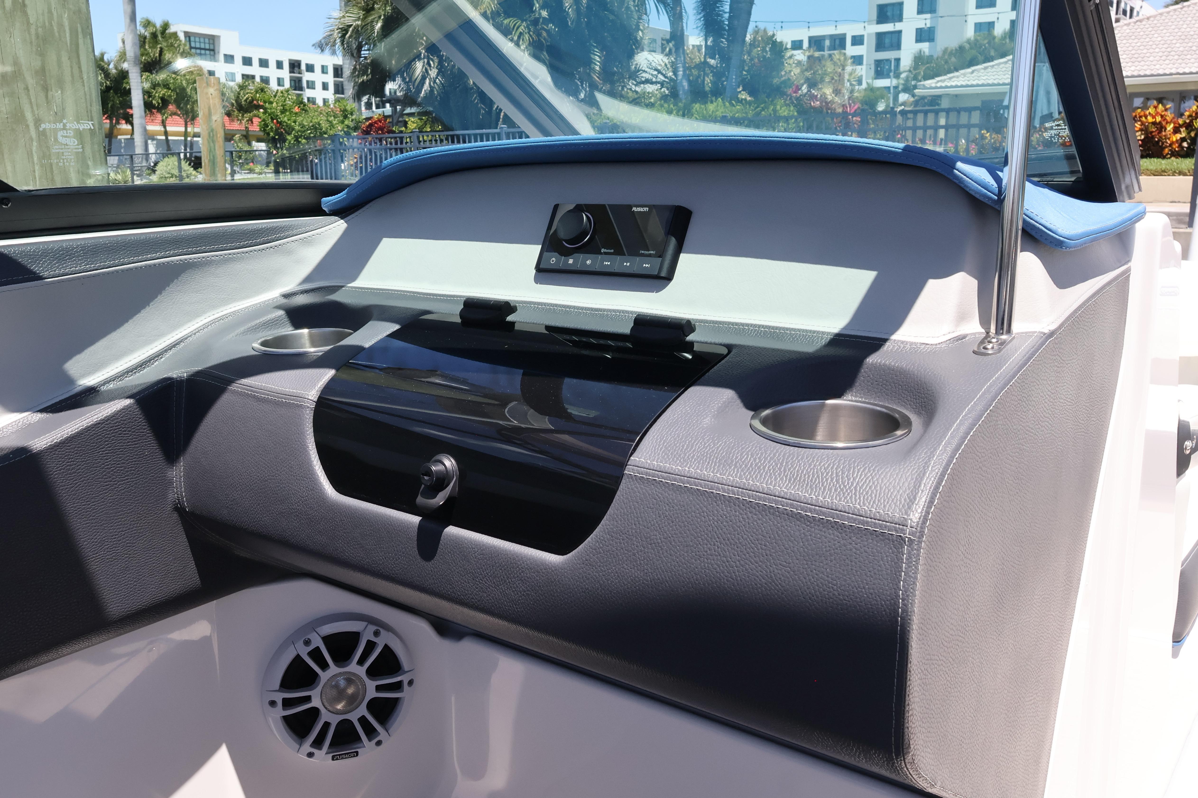 2020 Regal LX4 boat dashboard with cup holders and speaker, featuring modern design elements.