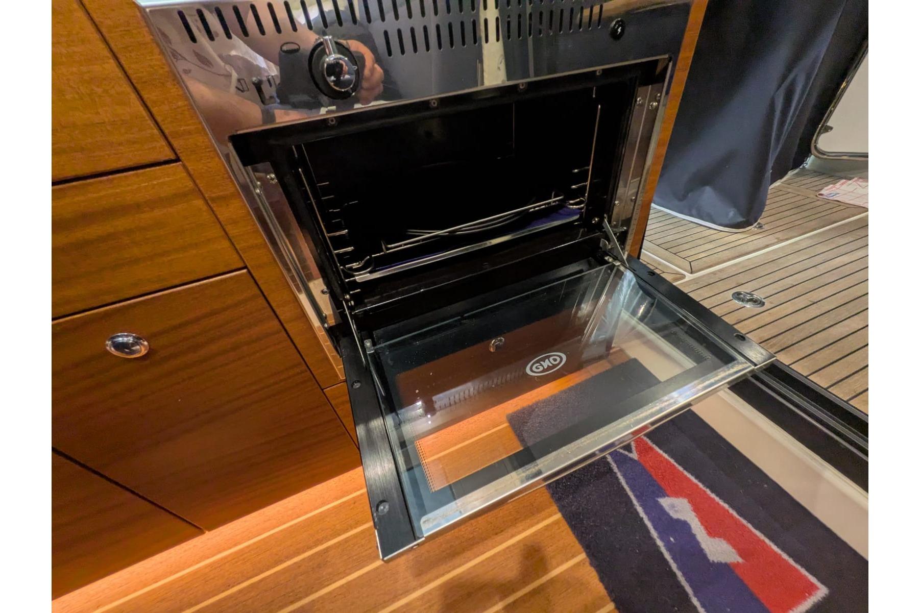 Open oven in the kitchen of a 2016 Nimbus Boats 305 Coupé.
