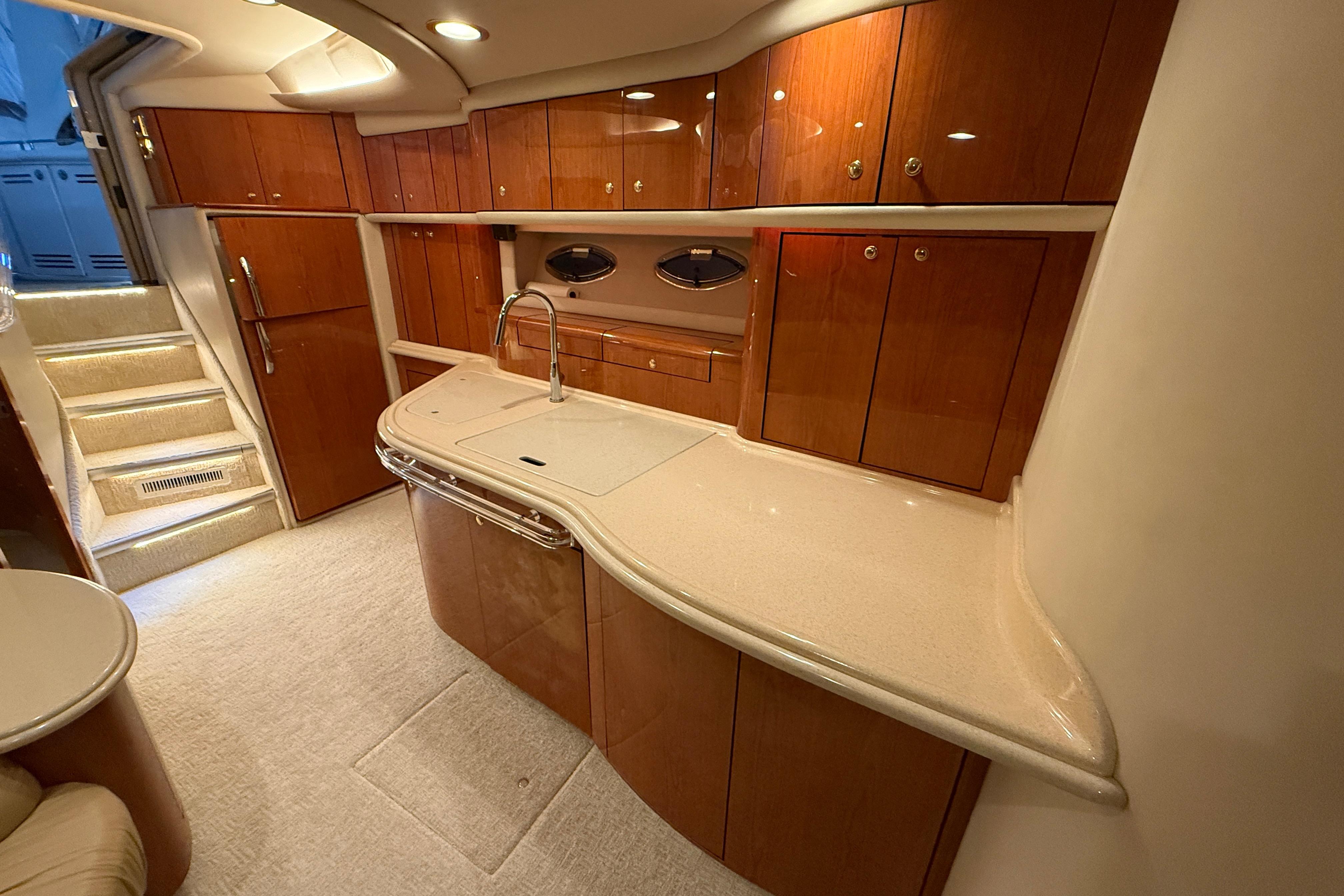 Luxurious interior of 2000 Sea Ray Sundancer 540 yacht with elegant wood cabinetry.