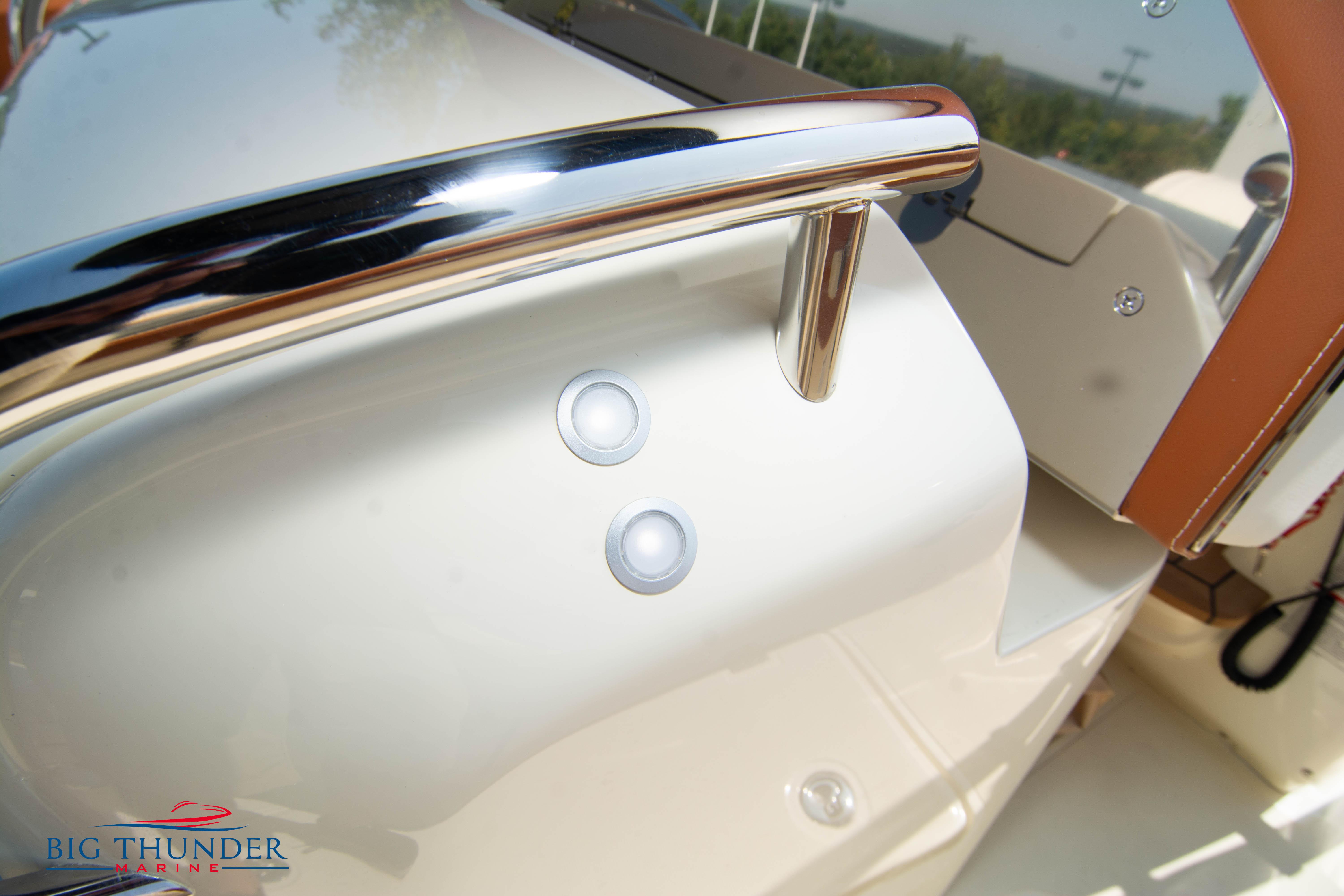 2024 Capoforte FX270 boat detail with chrome railing and control buttons.