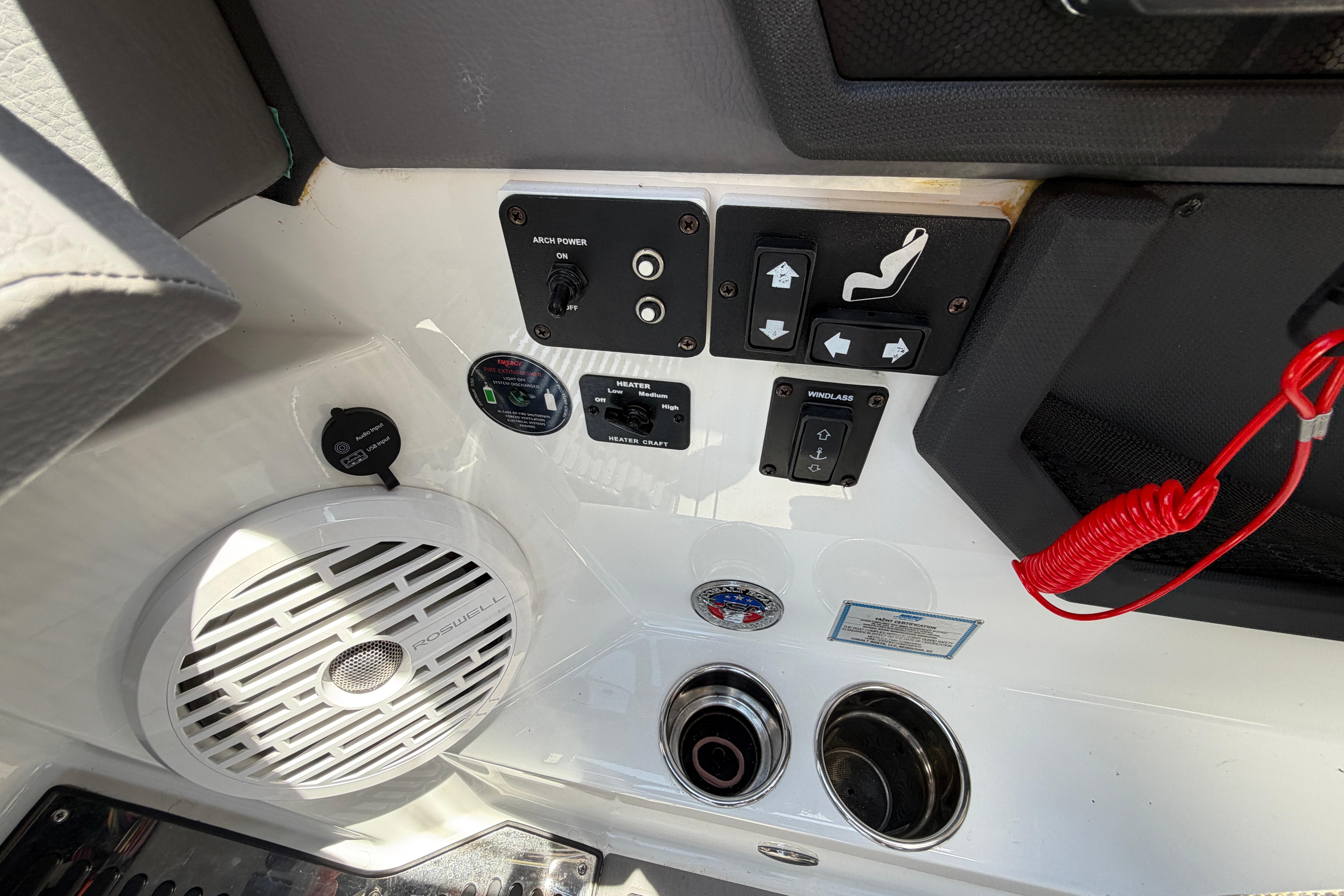 Control panel of 2021 Cobalt R8 Surf boat with speaker and switches.