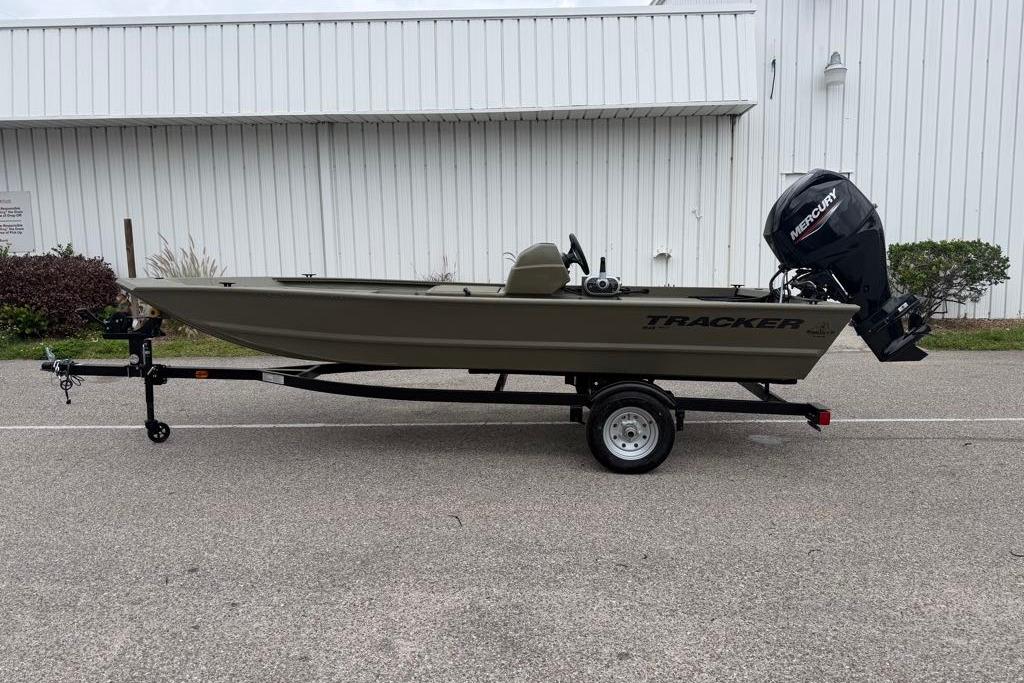 2026 Tracker Grizzly 1648 SC boat on trailer, parked outdoors.