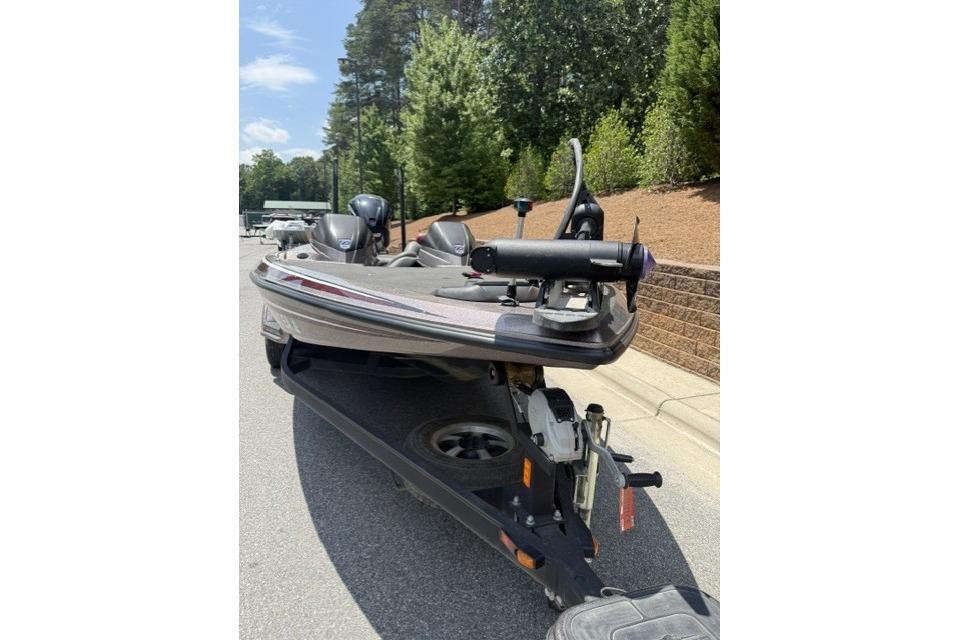 2013 Skeeter FX21 bass boat on trailer, parked on a sunny street.