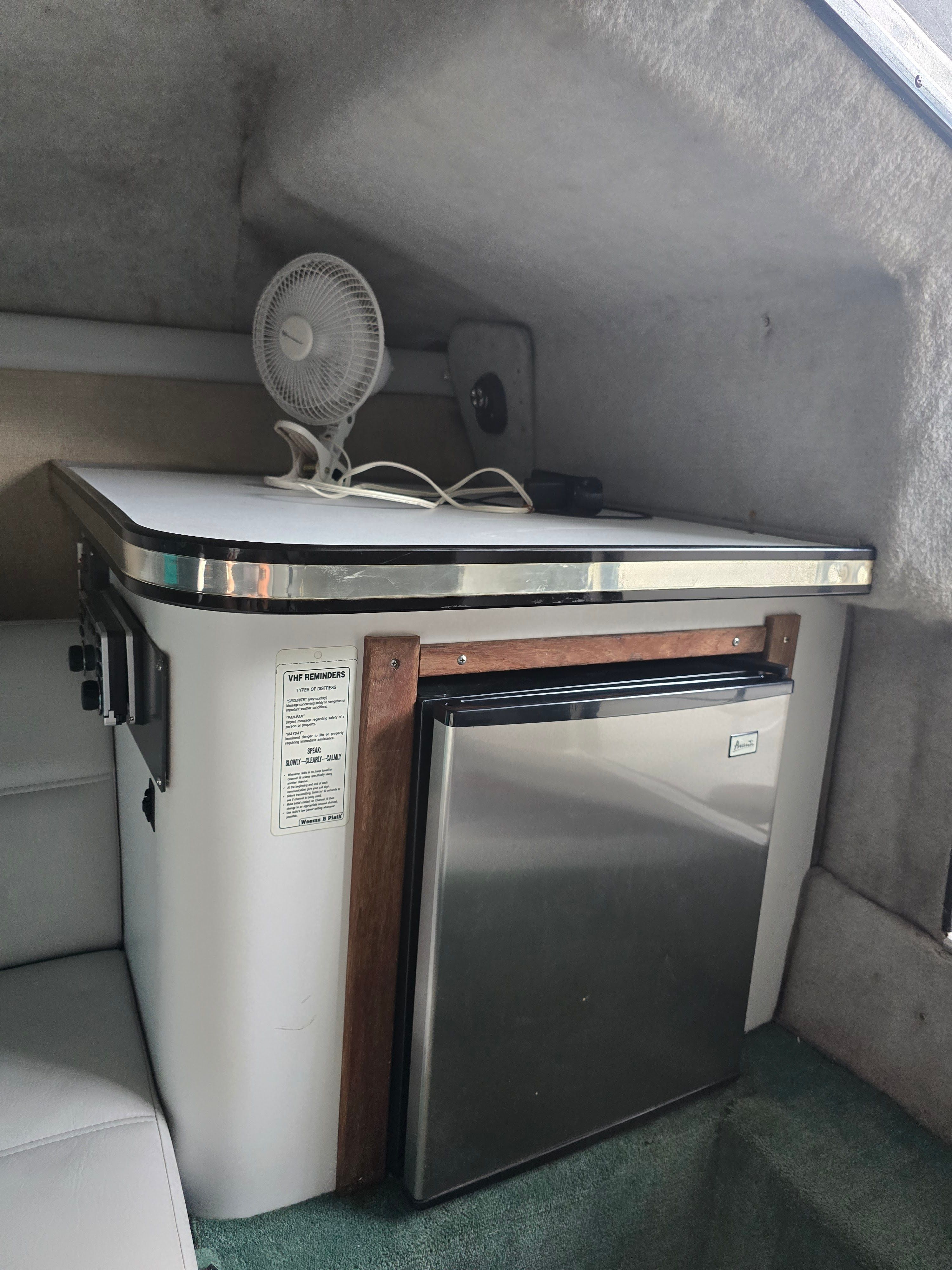 Interior of 1989 Baja 280 Sport with fridge and fan.