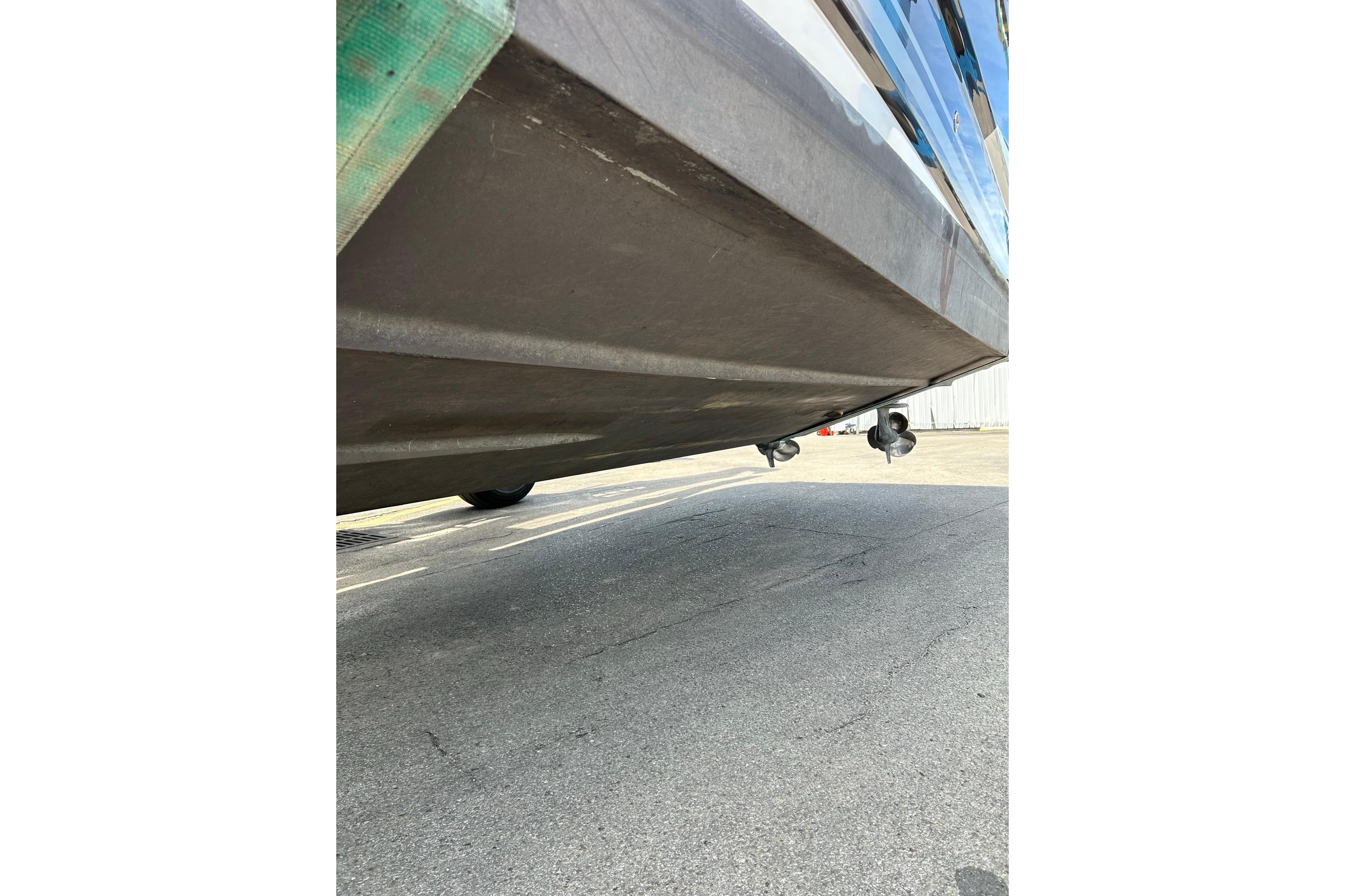 Underside view of a 2019 Monterey 335 Sport Yacht on pavement.
