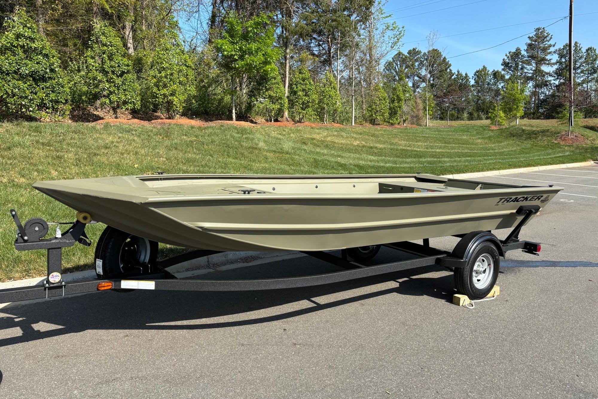 2026 Tracker Grizzly 1754 Utility boat on trailer, parked outdoors.