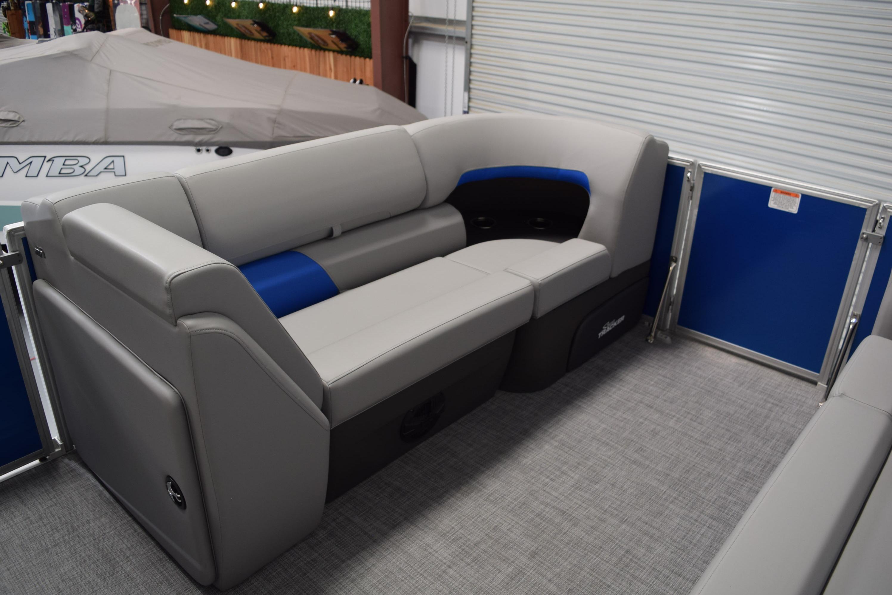 2026 Sun Tracker Party Barge 20 DLX interior with gray and blue seating.