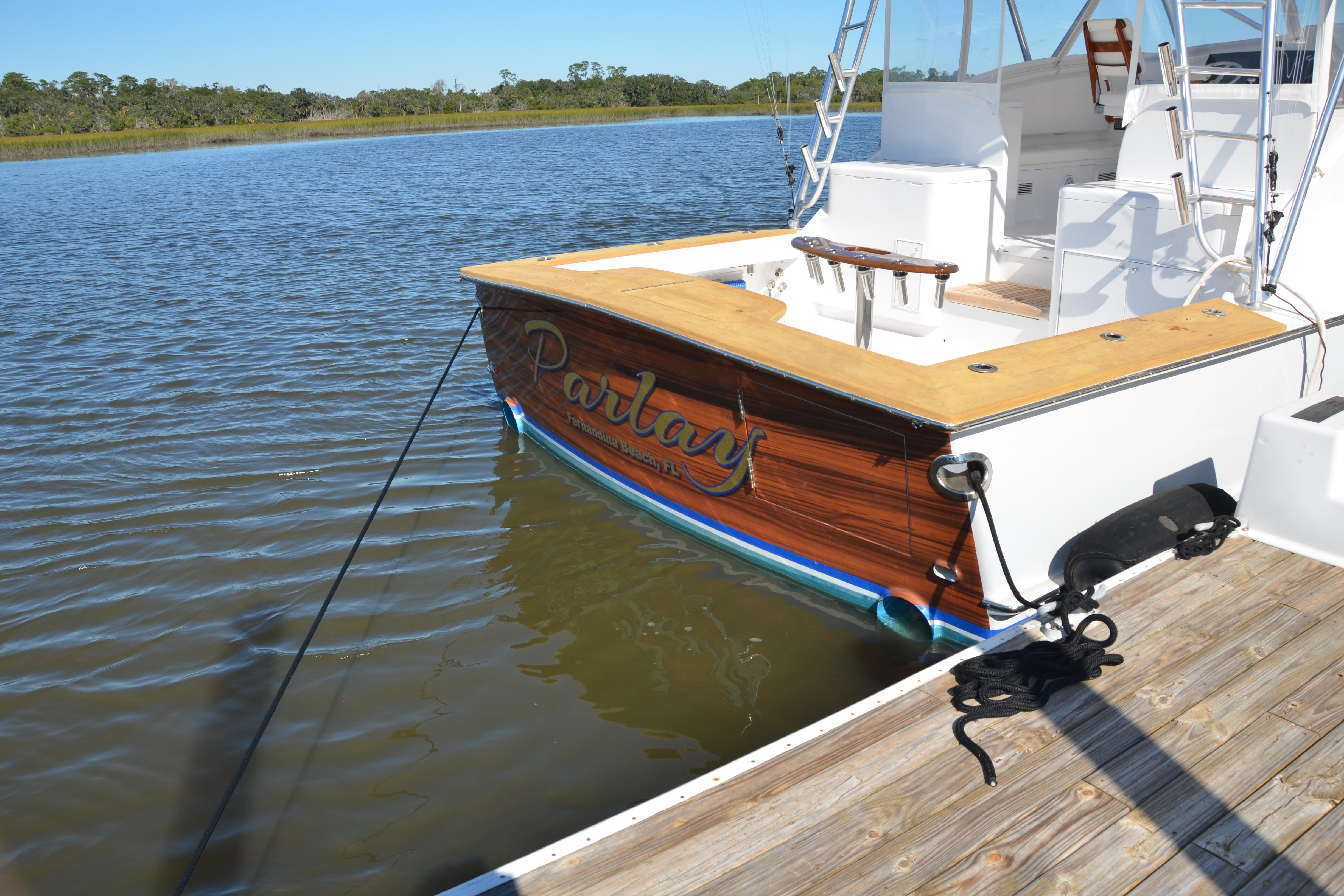 2006 Custom Carolina Heritage Express boat docked on calm water.