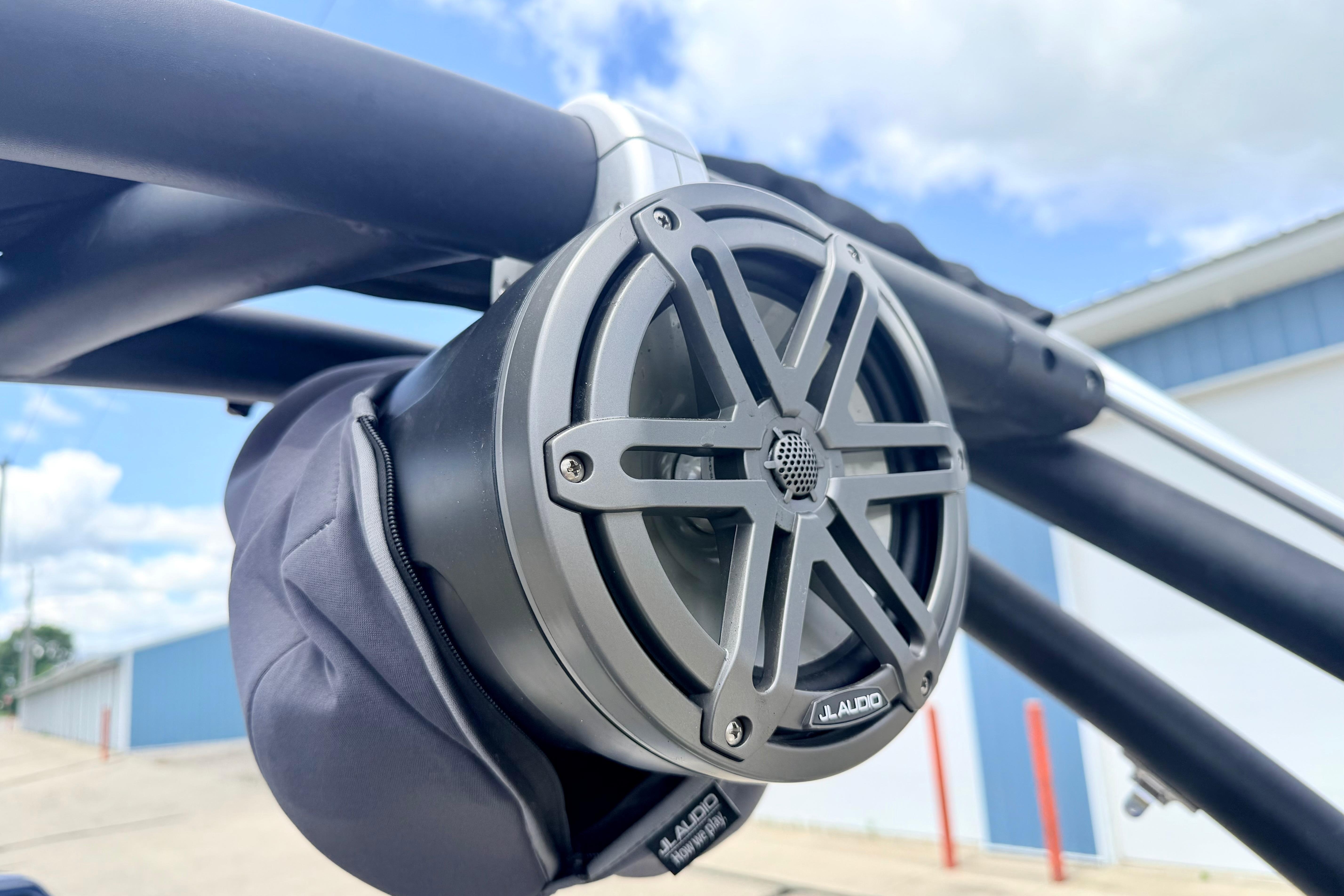 Close-up of JL Audio speaker on 2018 Glastron GT 185 boat, under blue sky.