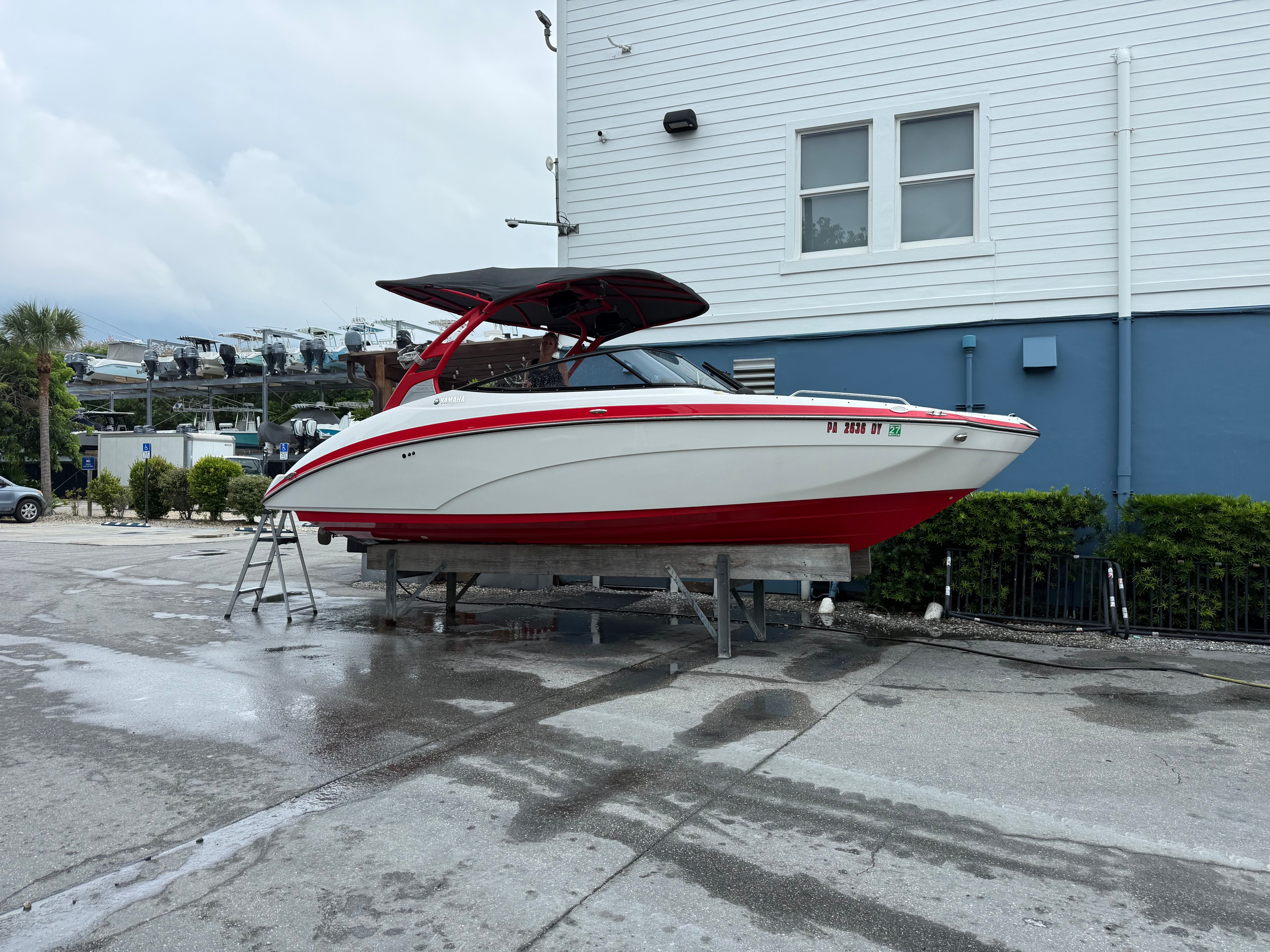 Yamaha AR242X 2020 boat on dry dock in front of a building.
