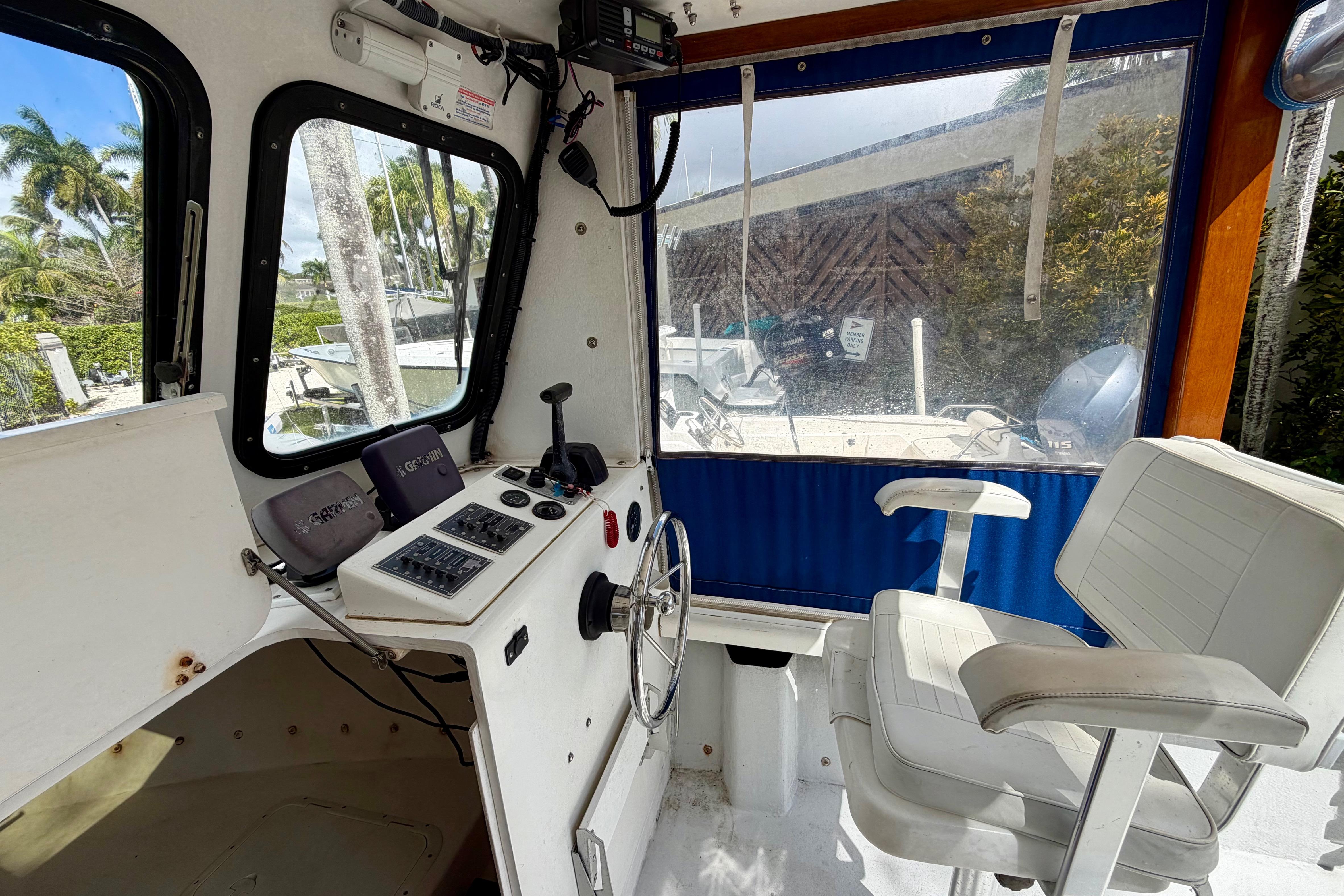 Interior of a 2000 Eastern 22 Lobster Fisherman boat with steering wheel and seating.