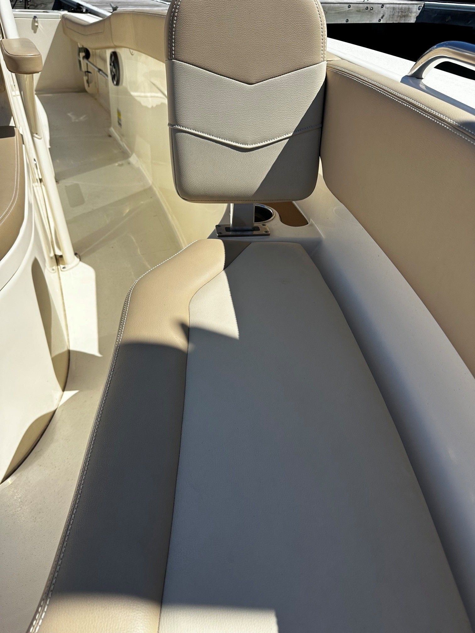 Interior of a 2022 Scout 210XSF boat with beige seating.