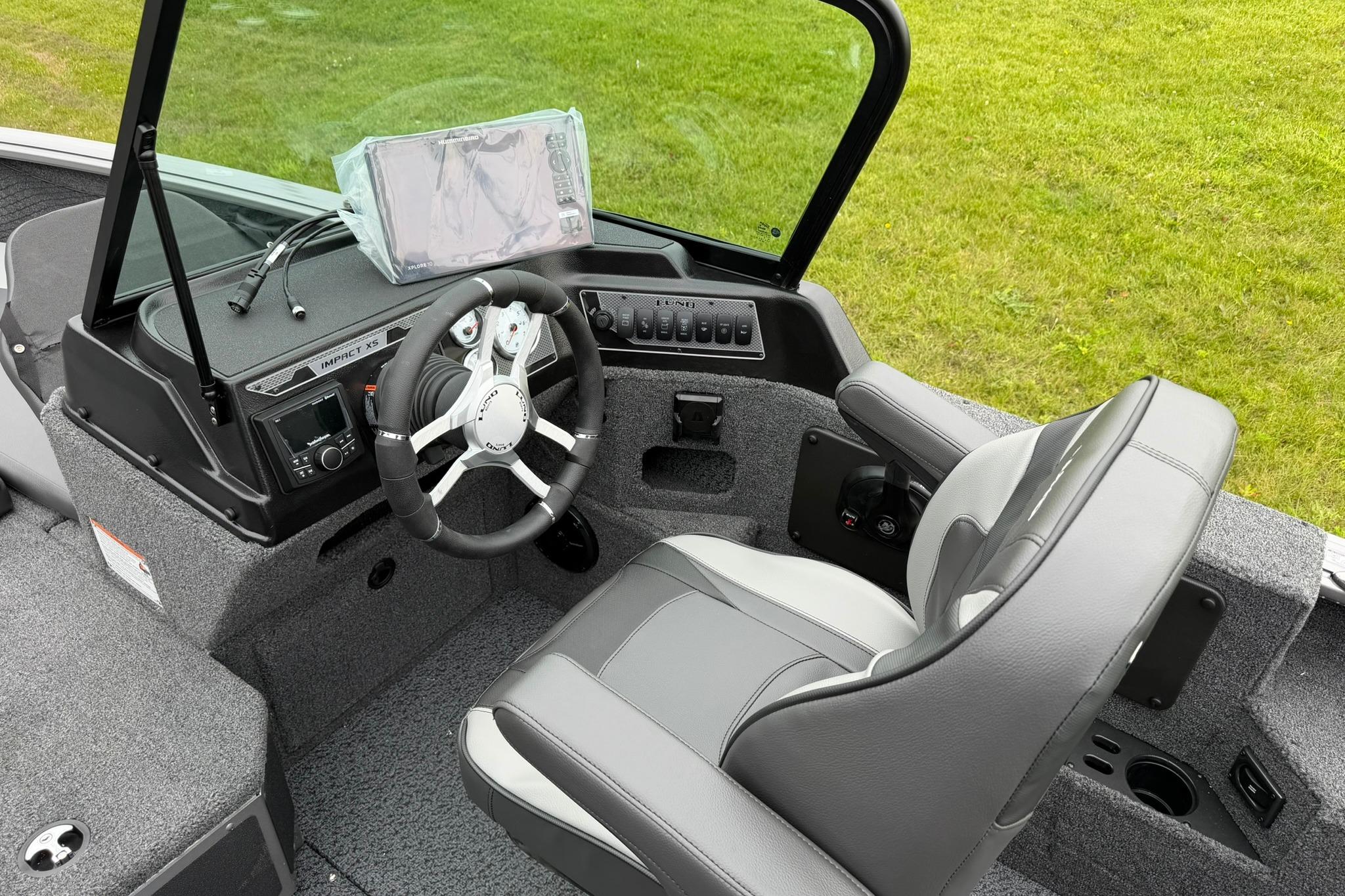 2027 Lund 2075 Impact XS boat interior with steering wheel and dashboard controls.