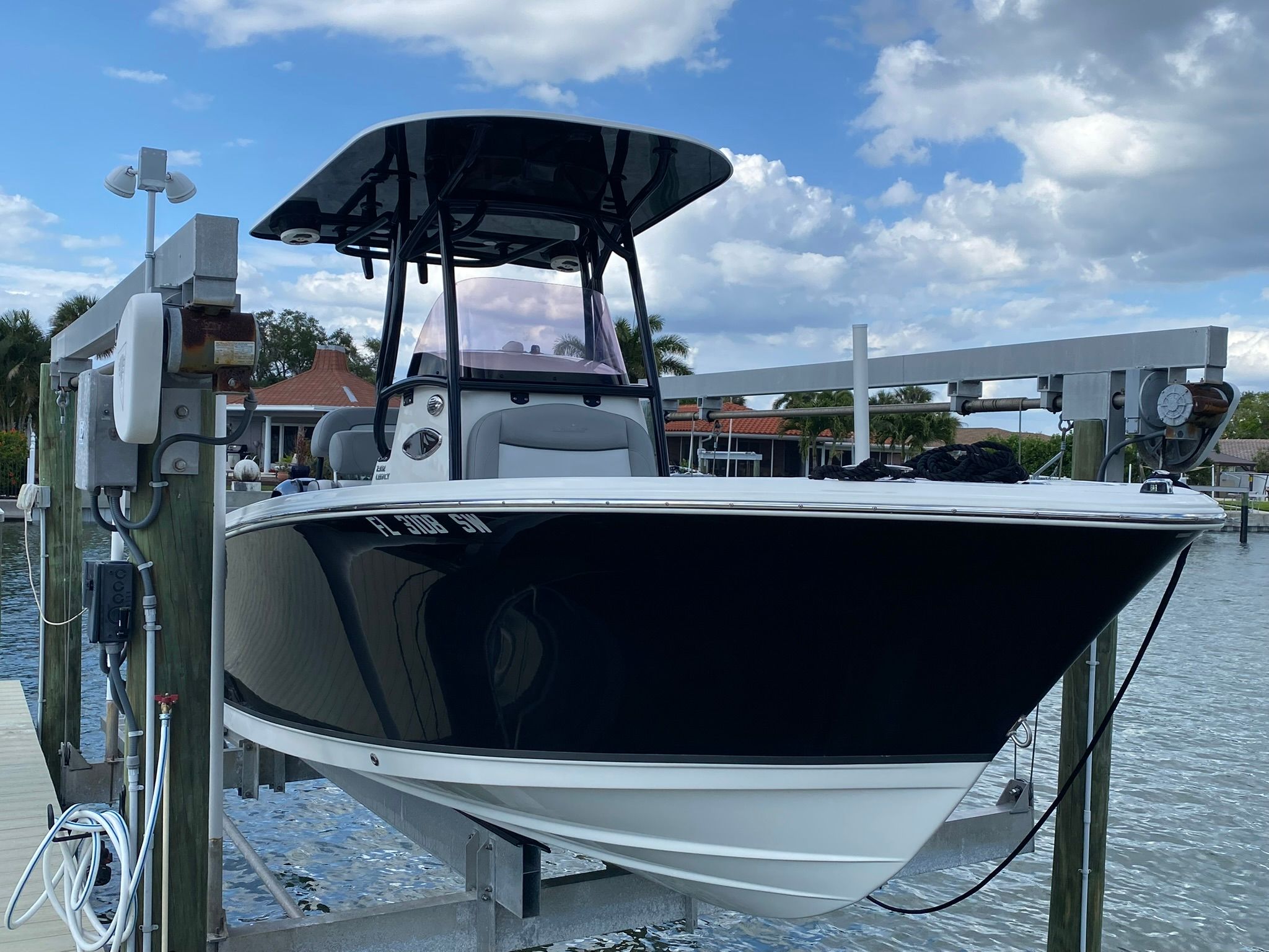 2021 NauticStar Legacy boat on a lift at the dock.