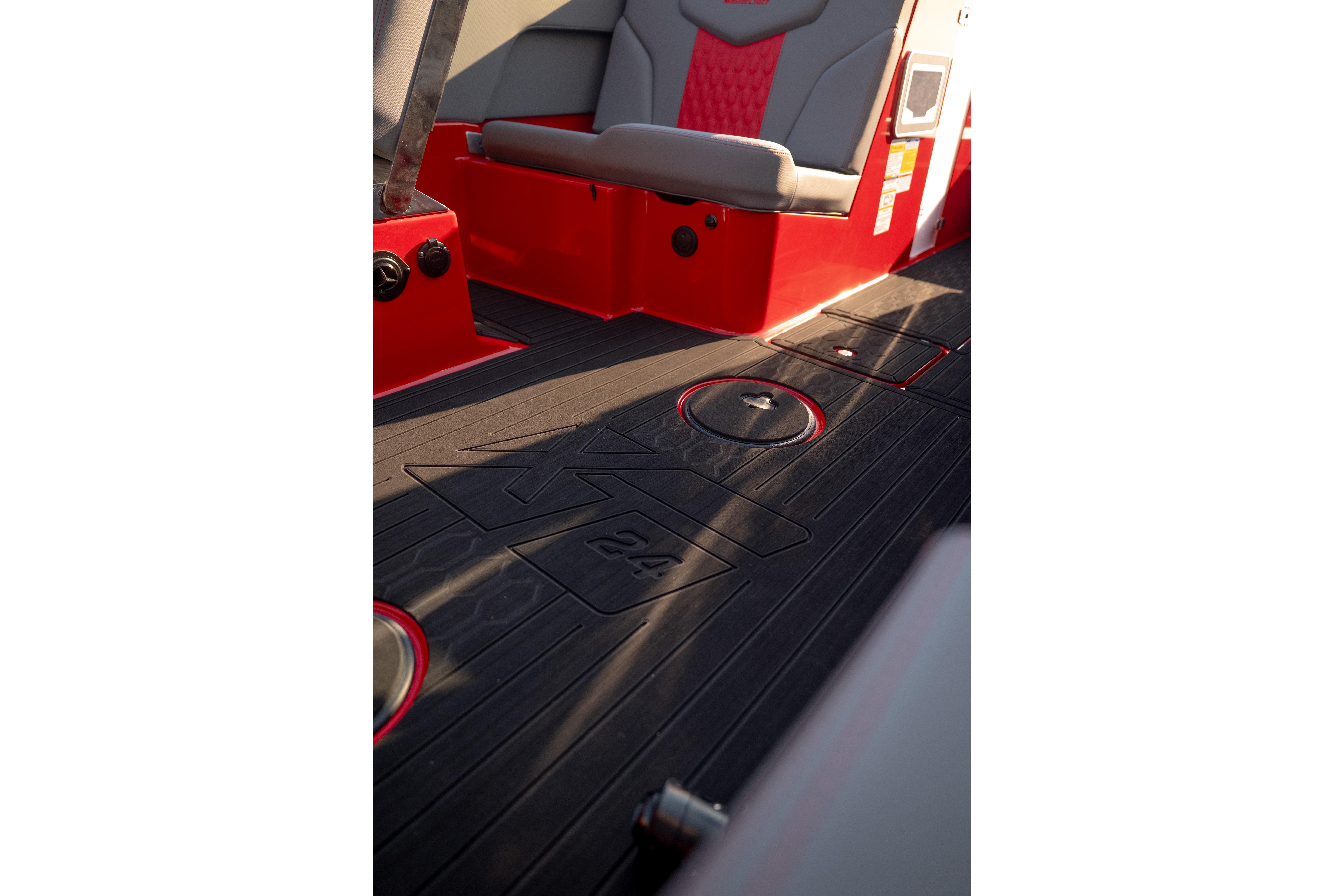 Interior view of 2027 MasterCraft XT24 boat with red and gray seating.