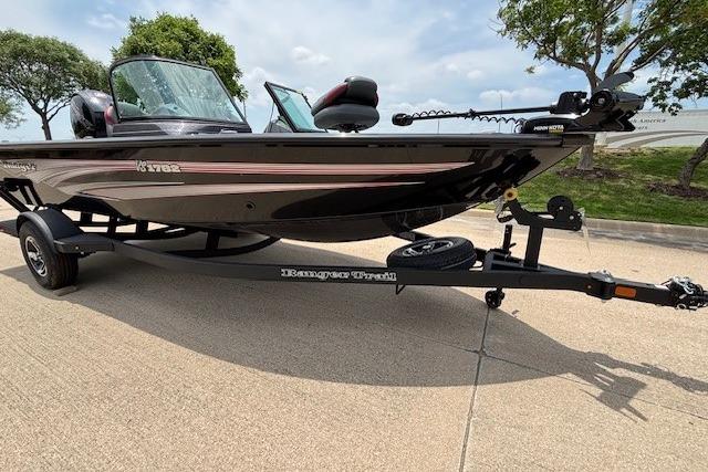 2026 Ranger VS1782SC Angler boat on trailer, parked outdoors, with trees in background.