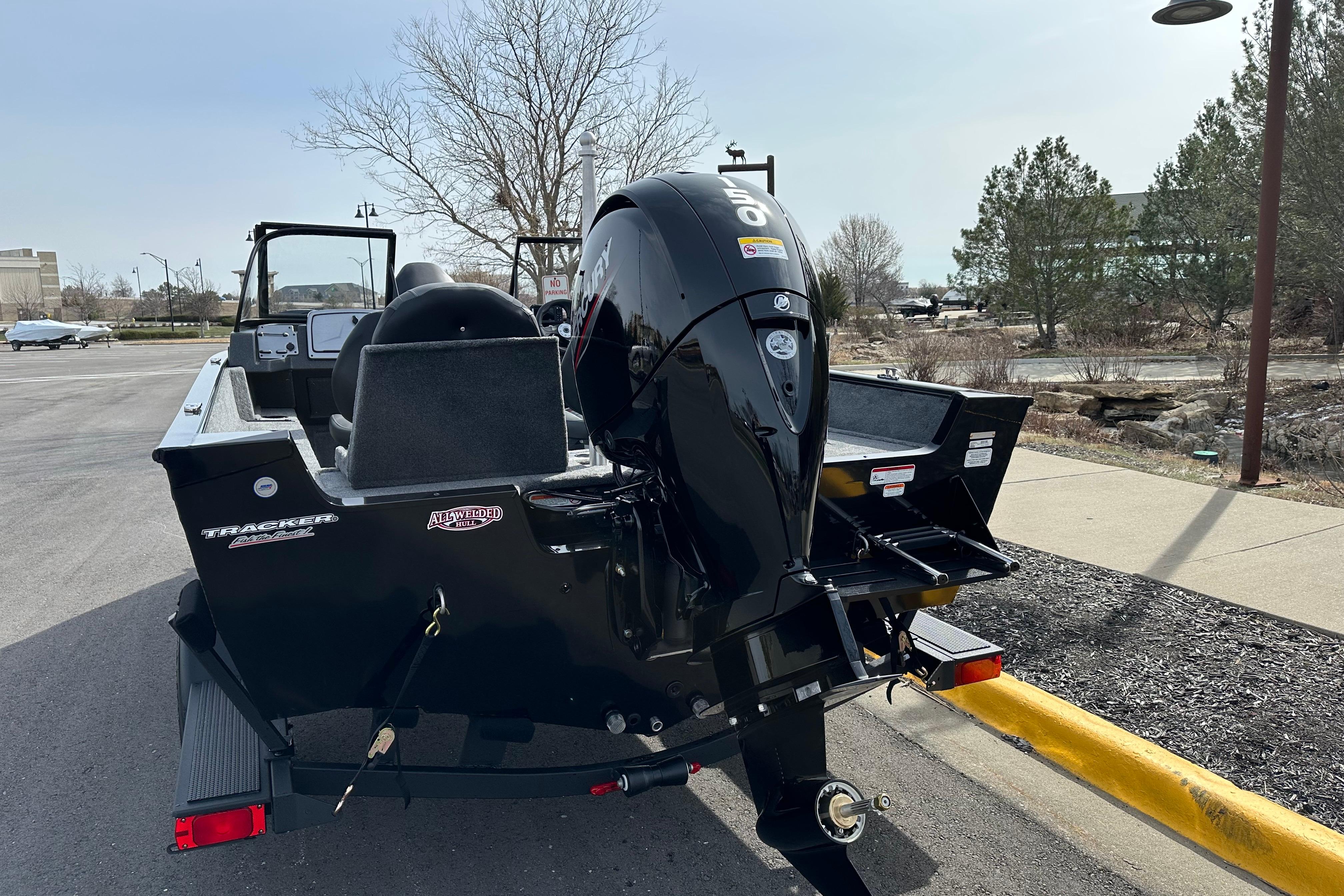 2026 Tracker Pro Guide V-175 Combo boat with powerful outboard motor in a parking lot.