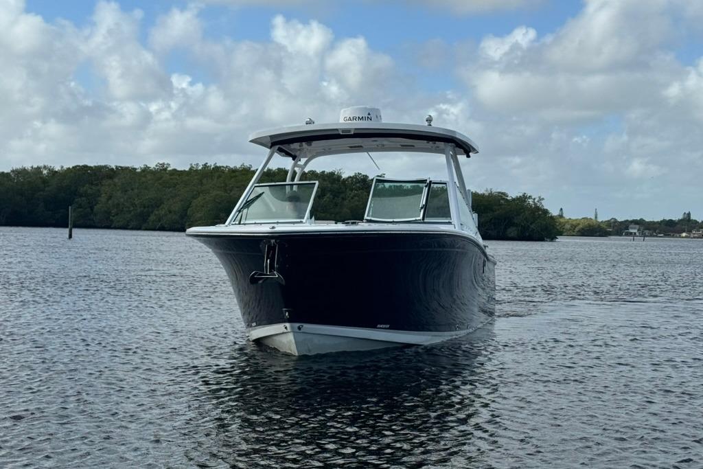 2023 Blackfin 272 DC boat on calm water under cloudy sky.