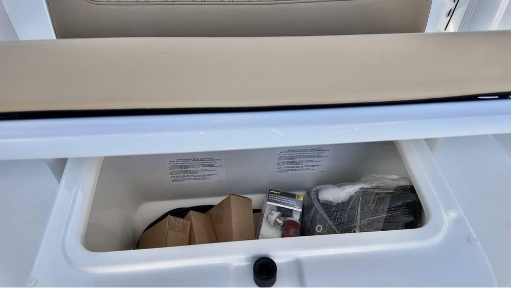 Storage compartment of 2025 Bayliner Trophy 22 CC boat, containing various items.