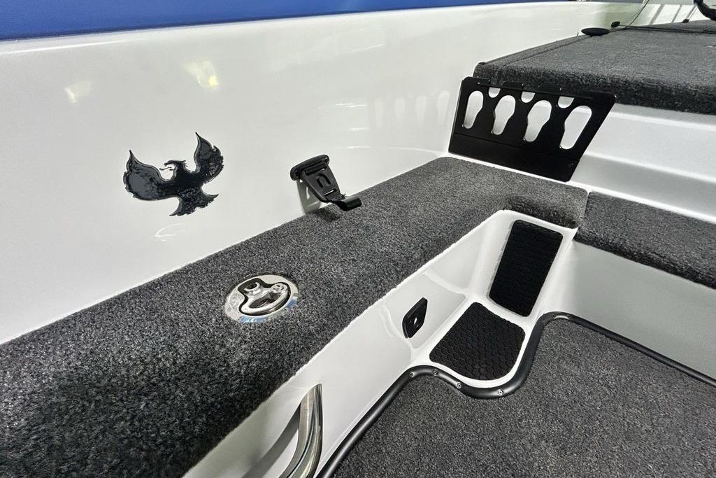 Interior of 2026 Phoenix 818 Pro boat with carpeted surfaces and logo detail.