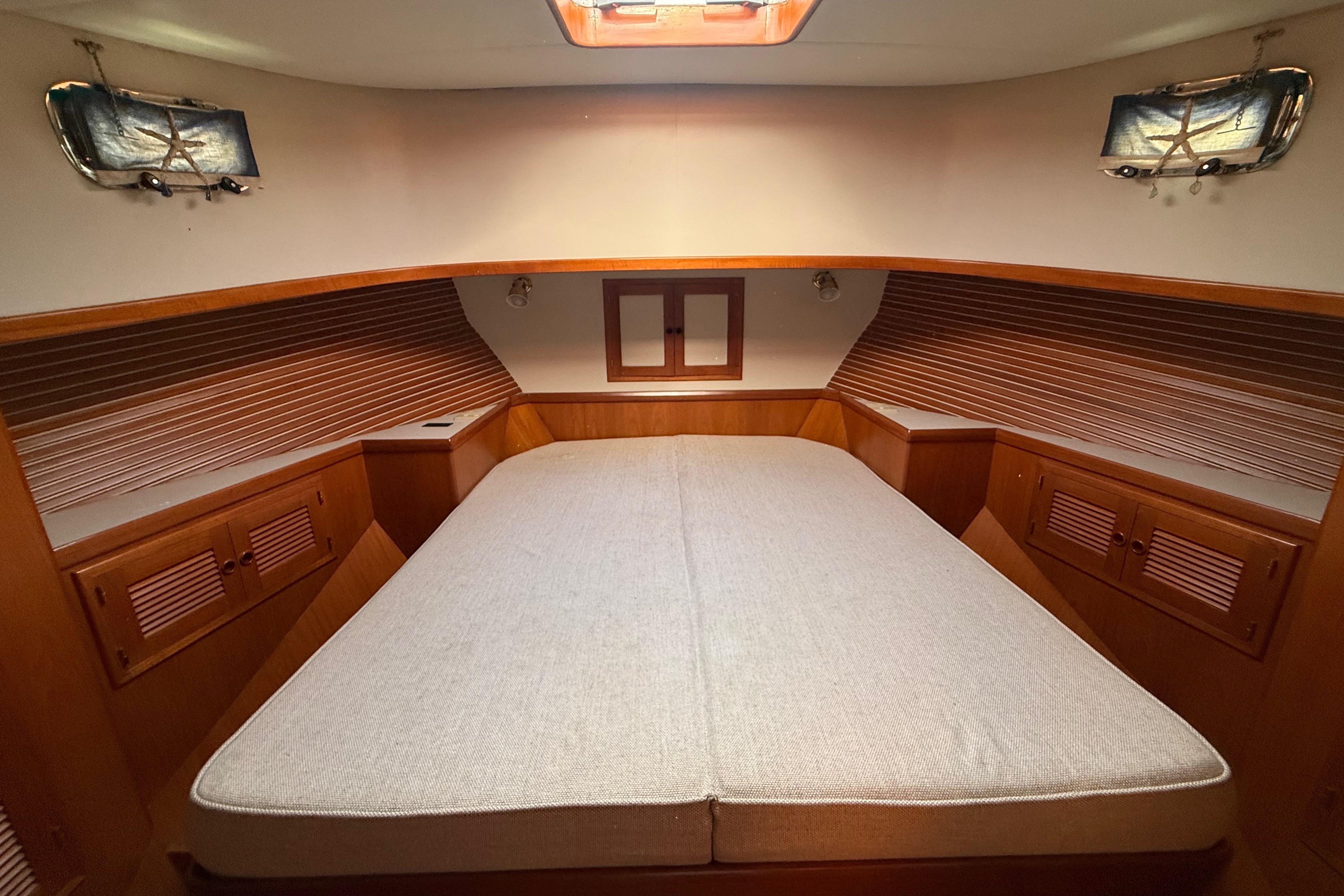 Cozy cabin interior of 2001 Kadey-Krogen 39 yacht with wooden accents and soft lighting.
