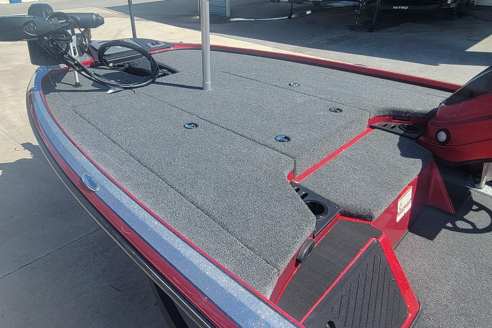 2026 Nitro Z18 boat deck with carpeted surface and fishing equipment.