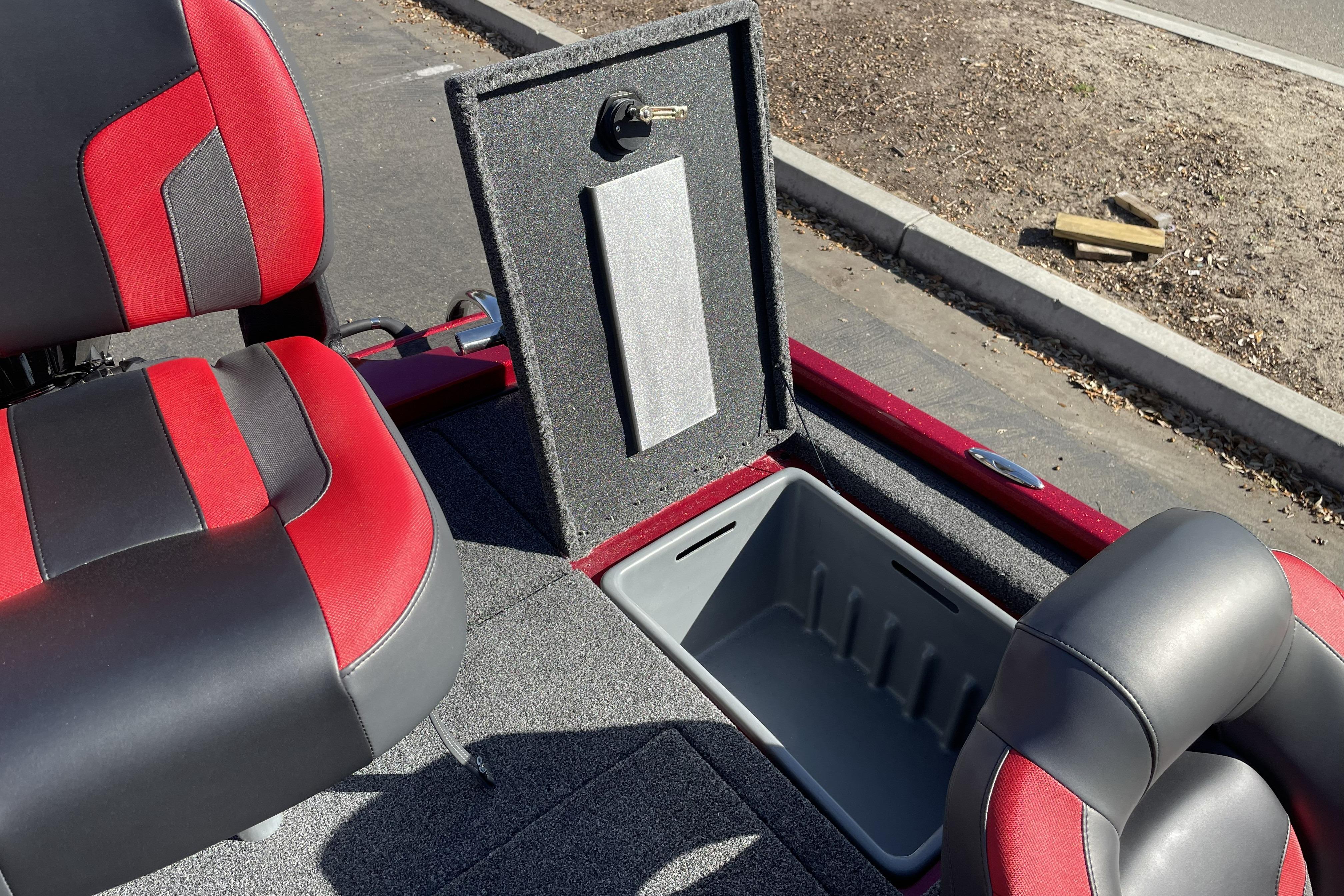 2026 Nitro Z19 XL boat interior with red and black seats and open storage compartment.