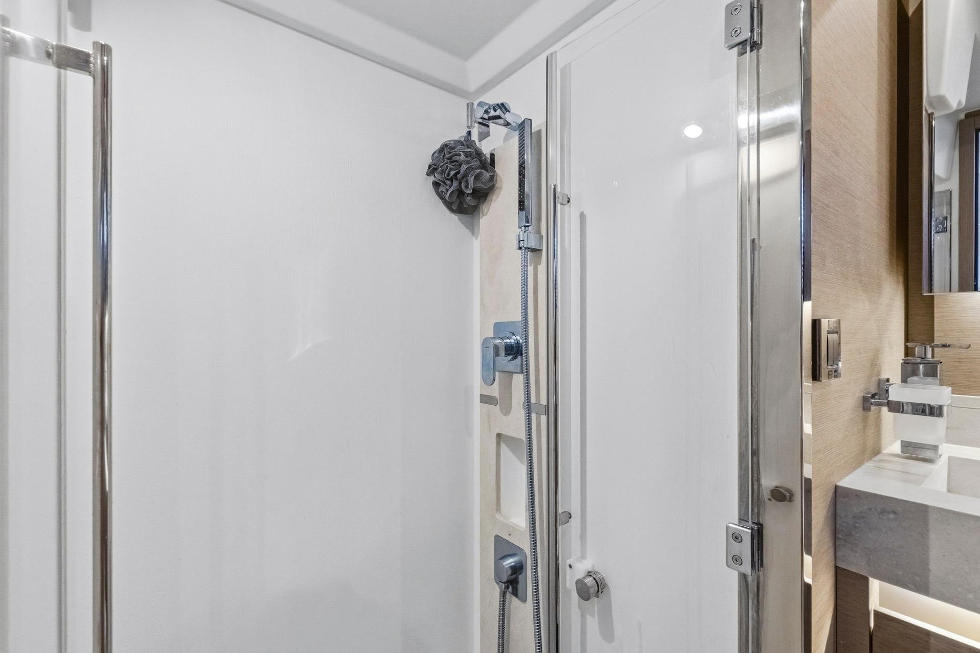 Modern shower area in 2022 Prestige 520 yacht, featuring sleek fixtures and elegant design.