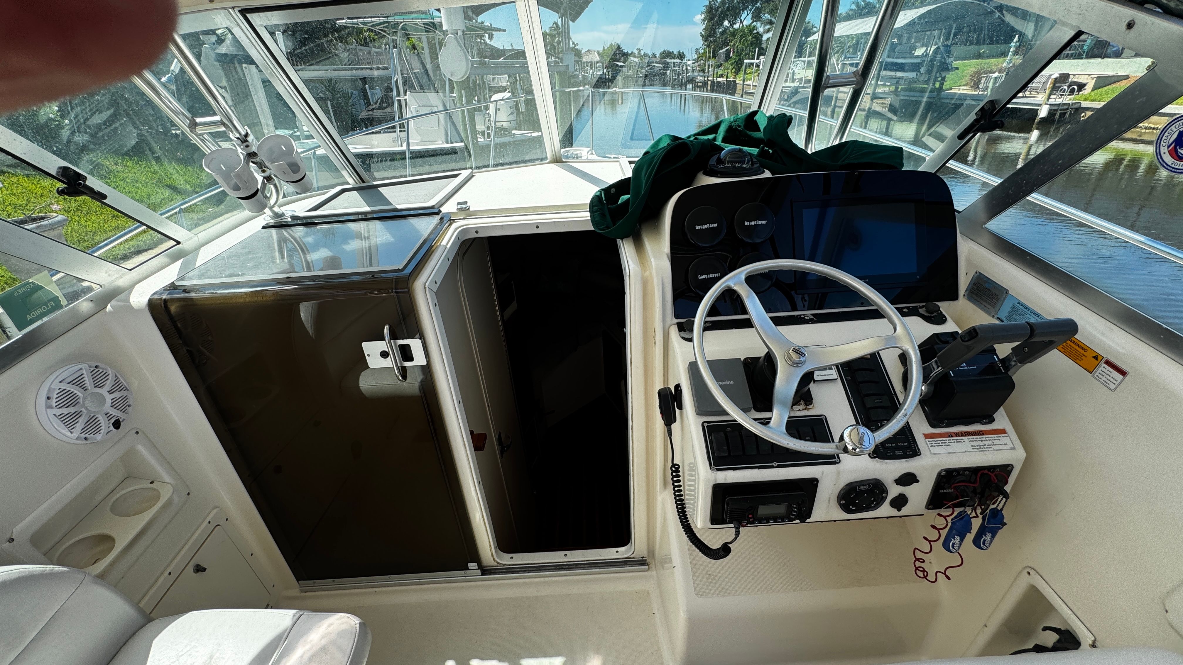 Interior view of a 2003 Pursuit 3070 boat with helm and cabin entrance.