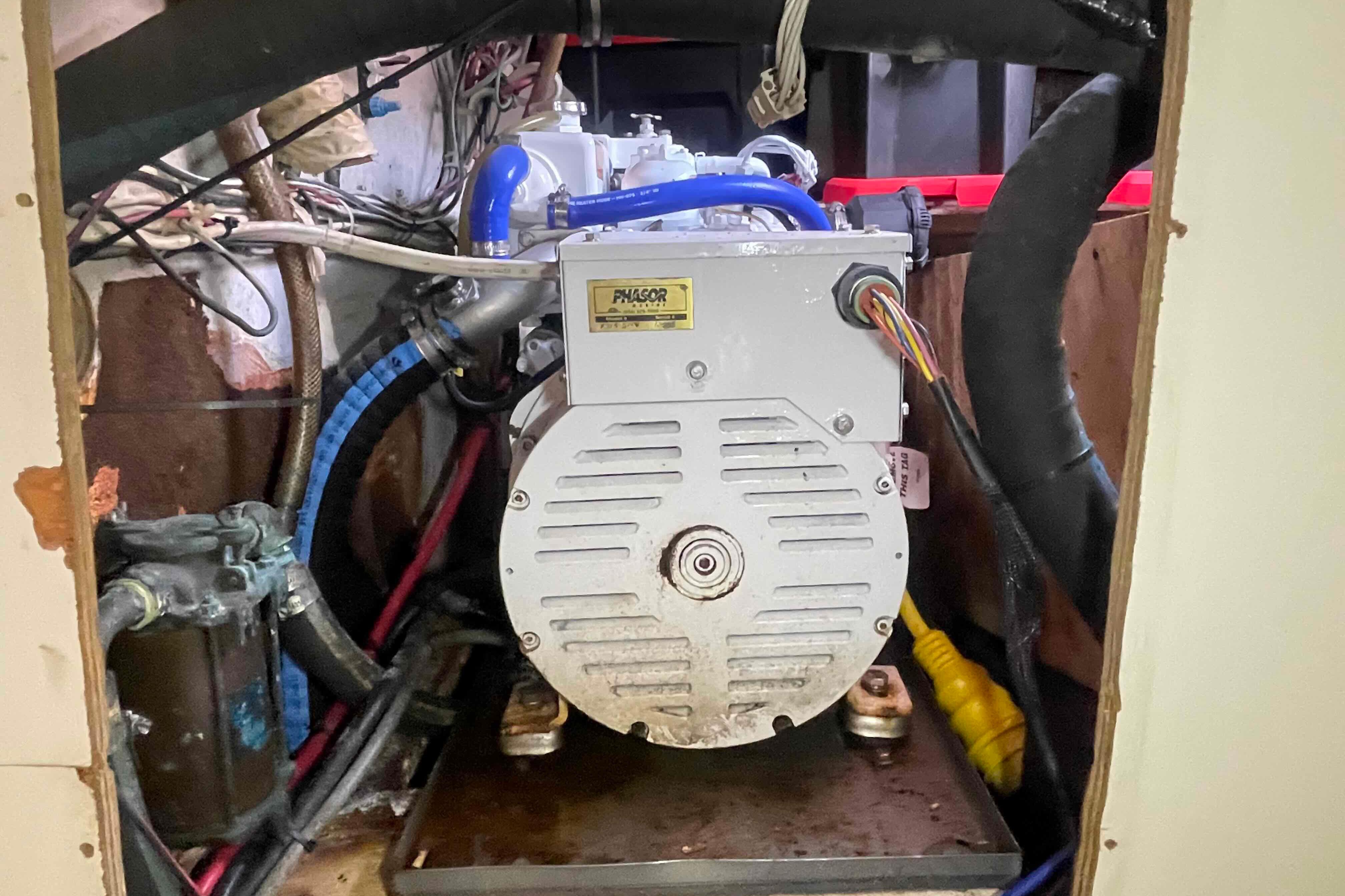 Engine compartment of a 1989 Island Packet 35 sailboat, featuring a Phasor generator.