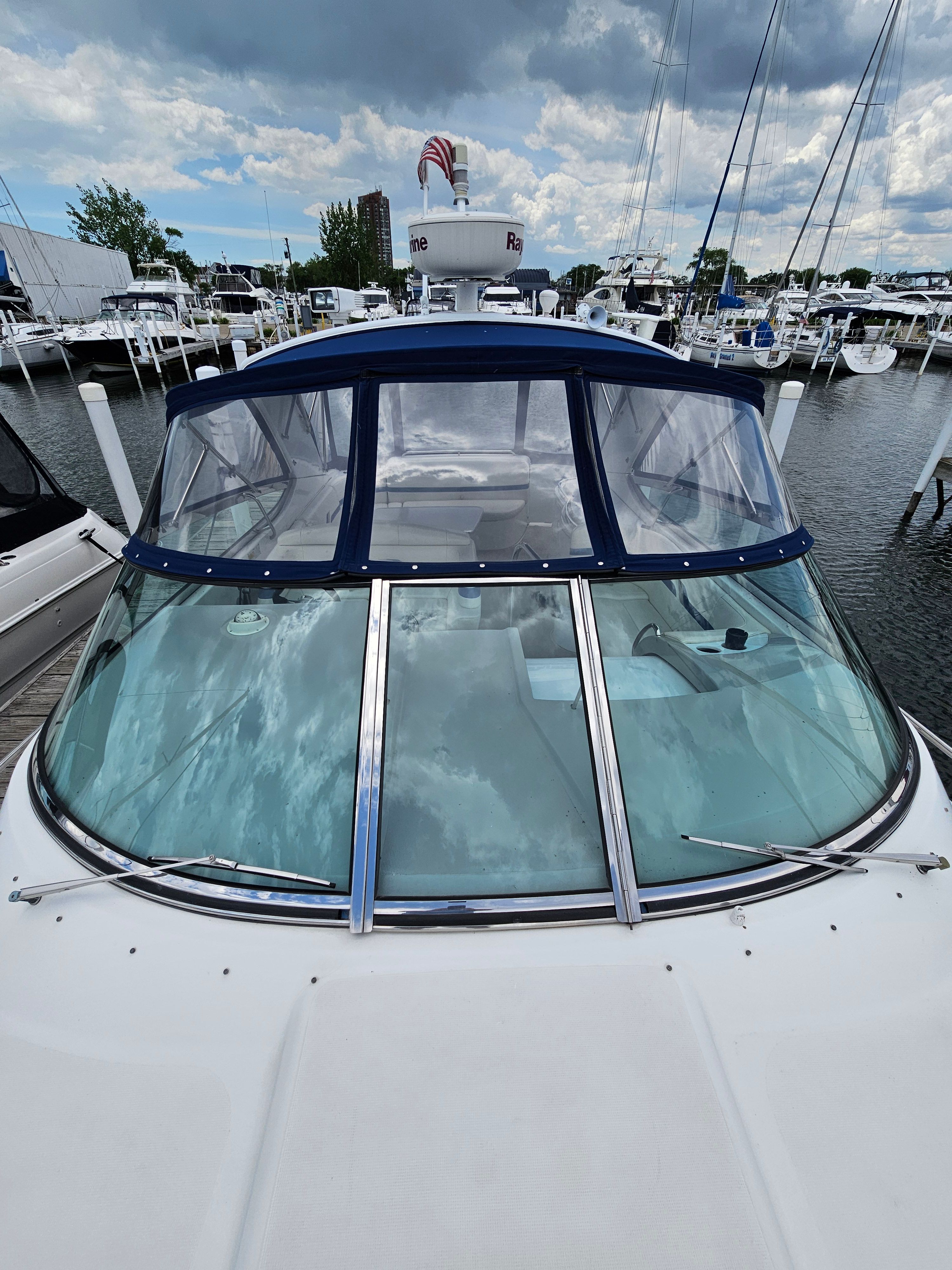 A 2001 Formula 400 Super Sport docked in a marina, surrounded by other boats.