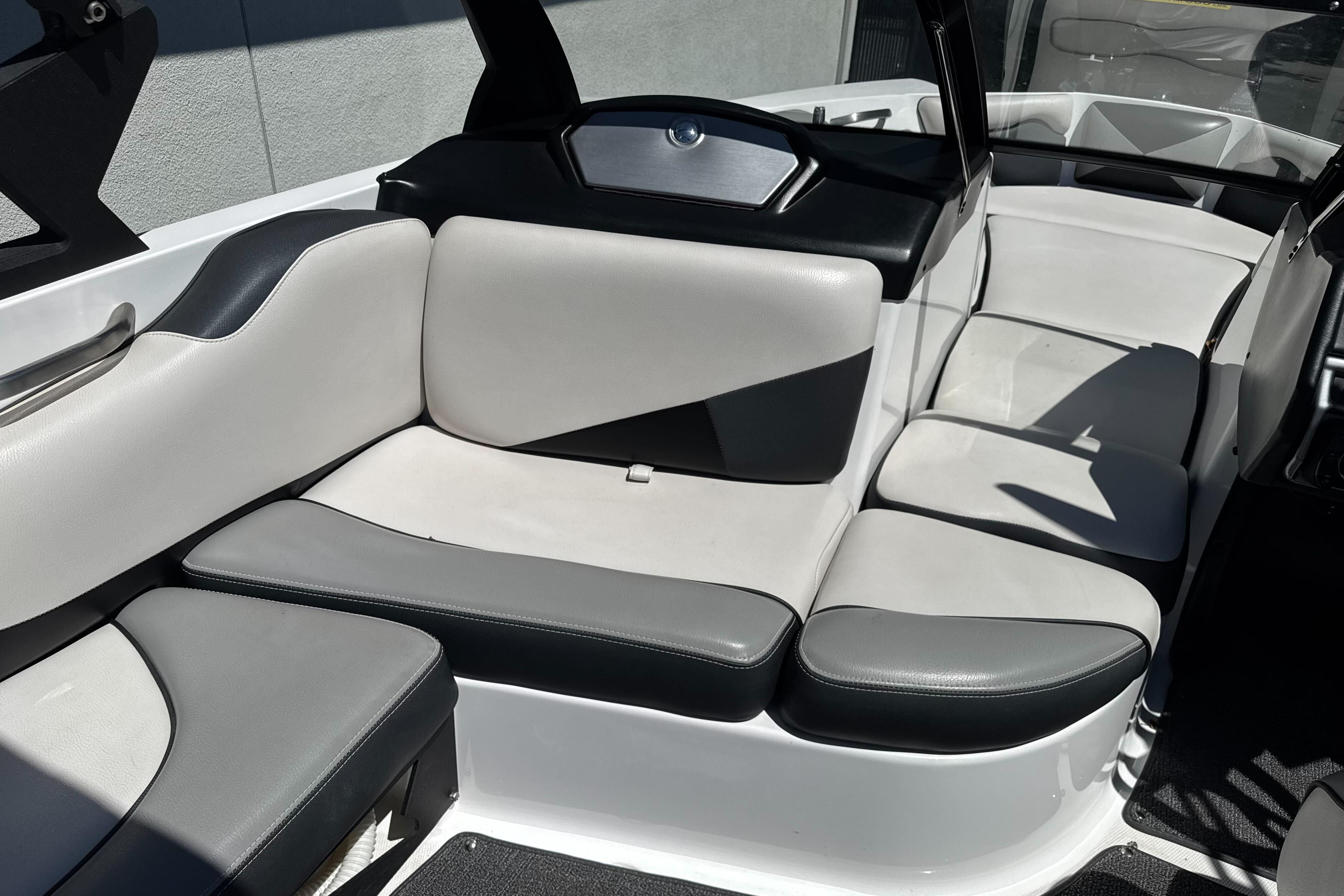 2015 Axis A20 boat interior with gray and white cushioned seating.