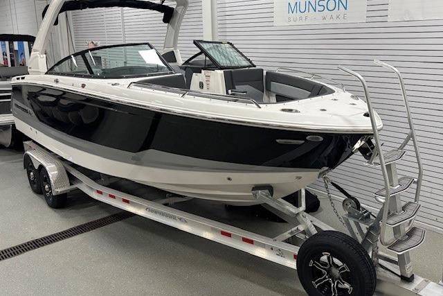 2026 Chaparral SSX 8 boat on trailer in showroom, sleek black and white design.