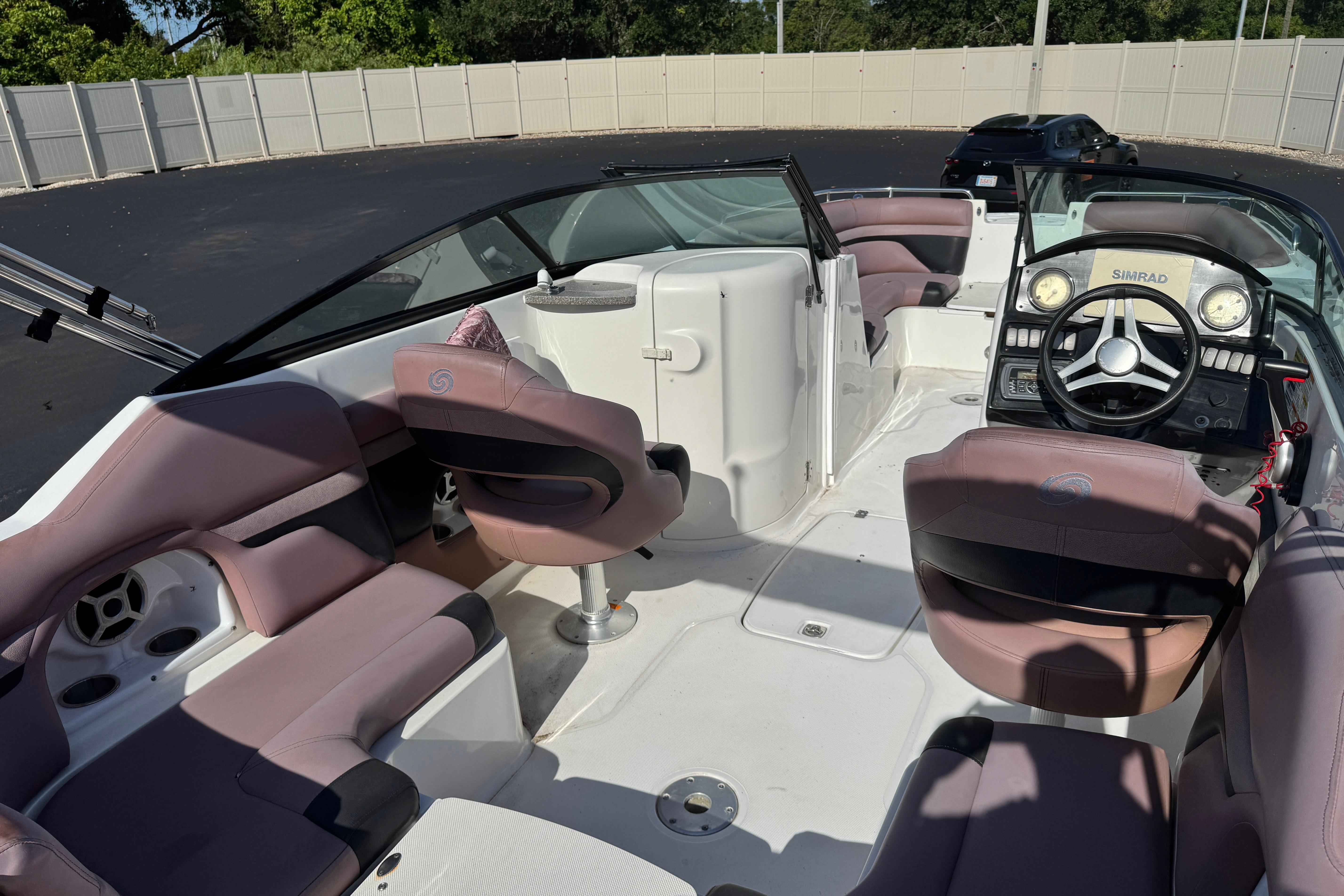 2018 Hurricane SunDeck 2400 OB boat interior with plush seating and modern dashboard.
