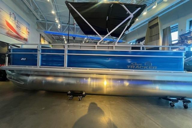 2026 Sun Tracker Fishin' Barge 20 DLX pontoon boat in showroom setting.