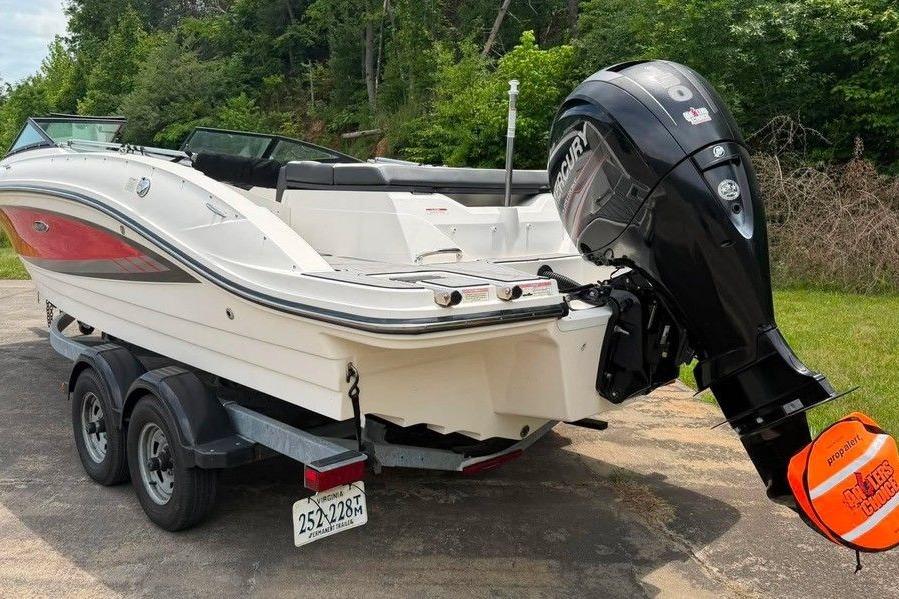 2016 Sea Ray 21 SPX boat on trailer with Mercury outboard motor, parked outdoors.
