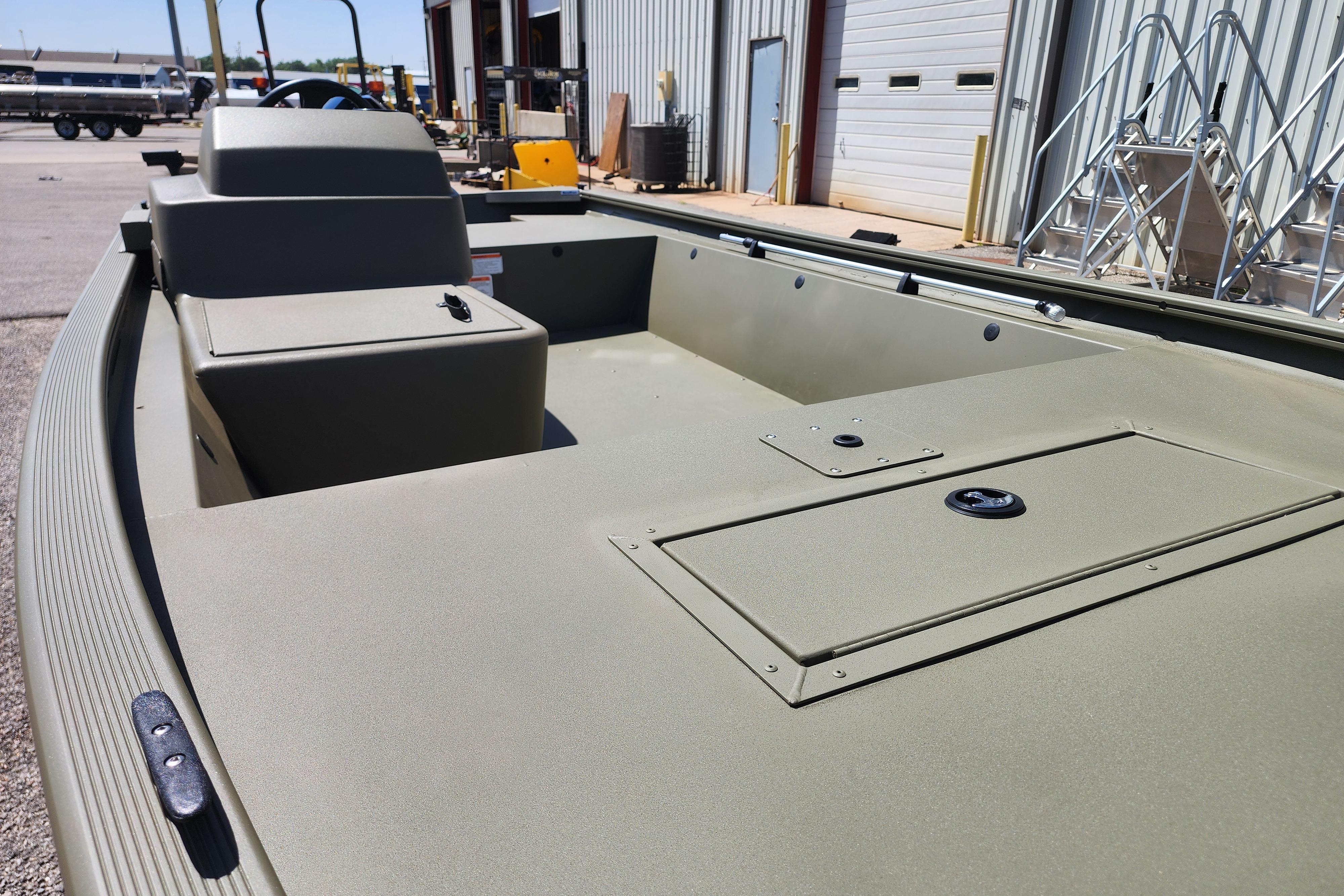 2026 Tracker Grizzly 1648 SC boat interior, showcasing storage compartments and seating.