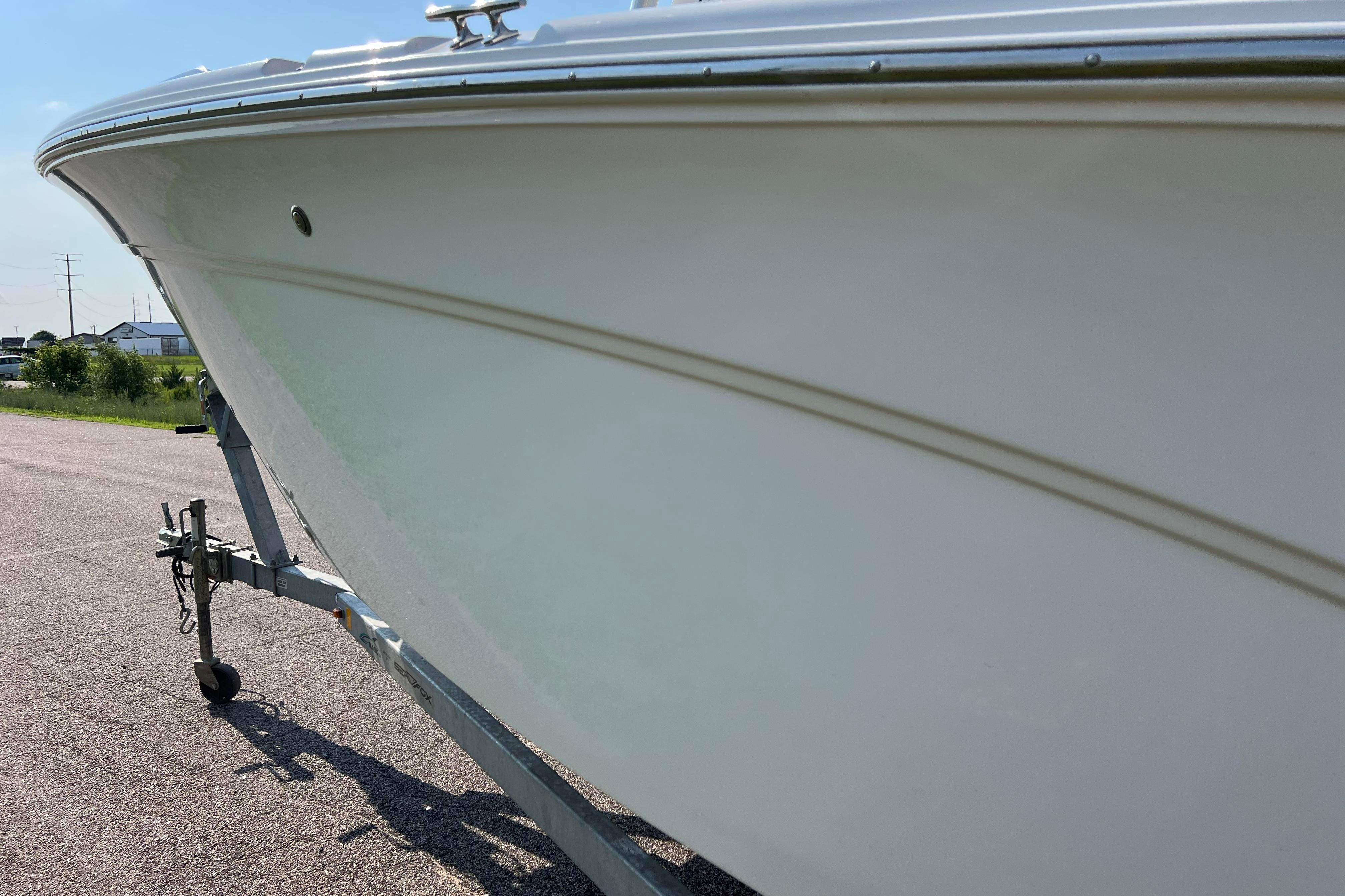 2012 Sea Fox 206 Center Console boat on trailer, side view.