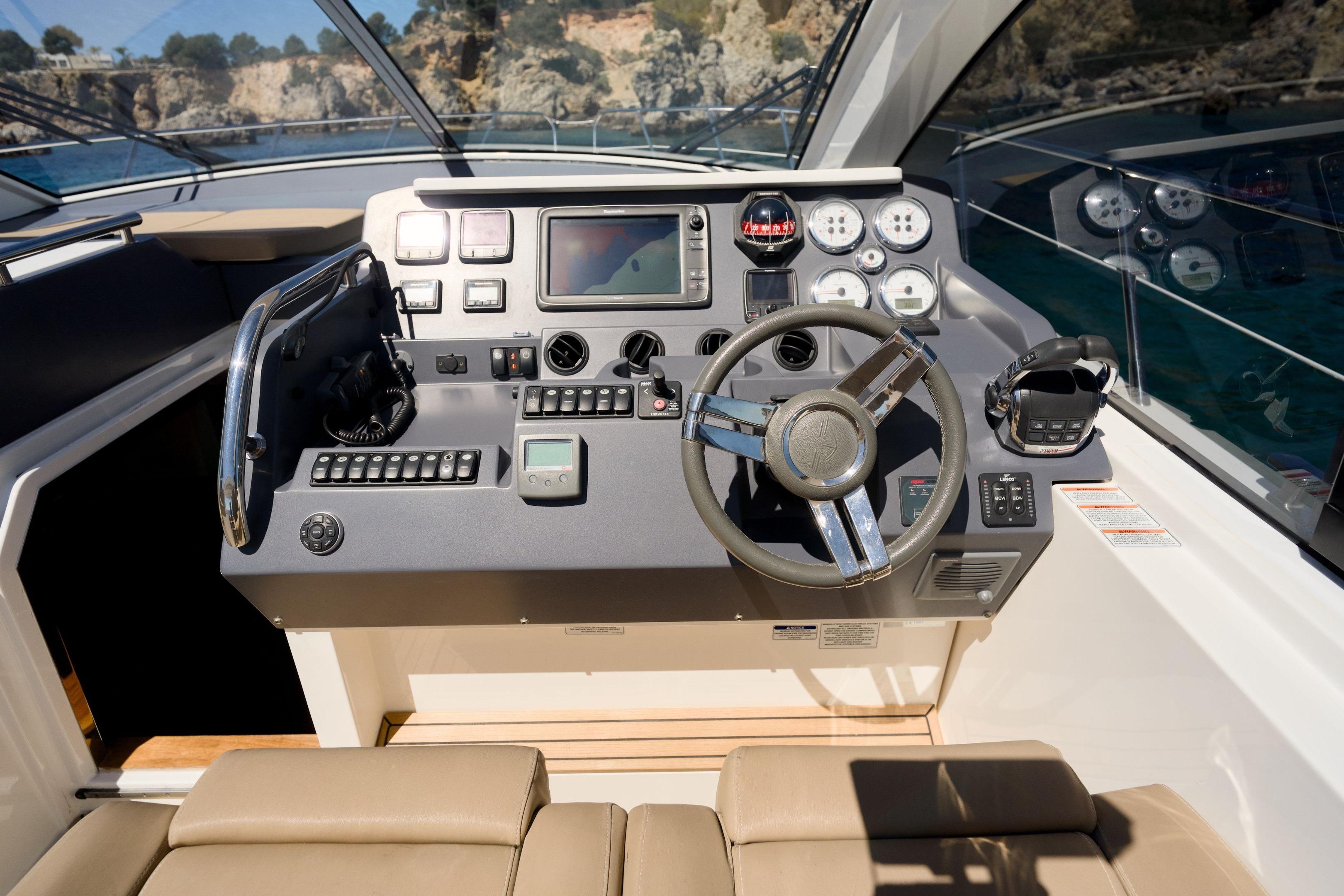 Cockpit of 2012 Sealine SC42 yacht with modern steering and control panel.