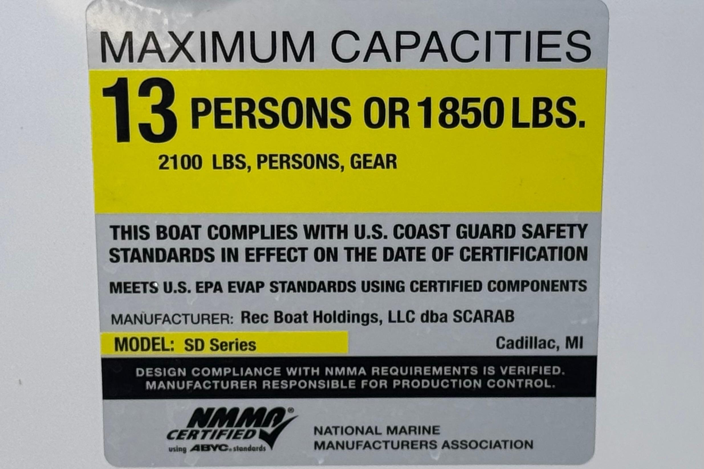 2017 Scarab 255 H.O. Platinum boat capacity label, 13 persons or 1850 lbs, safety standards.