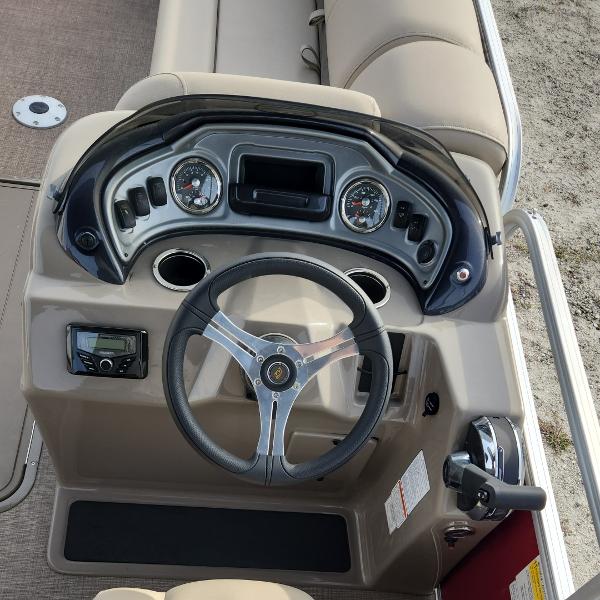 2023 Sun Tracker Party Barge 22 XP3 steering console with gauges and controls.
