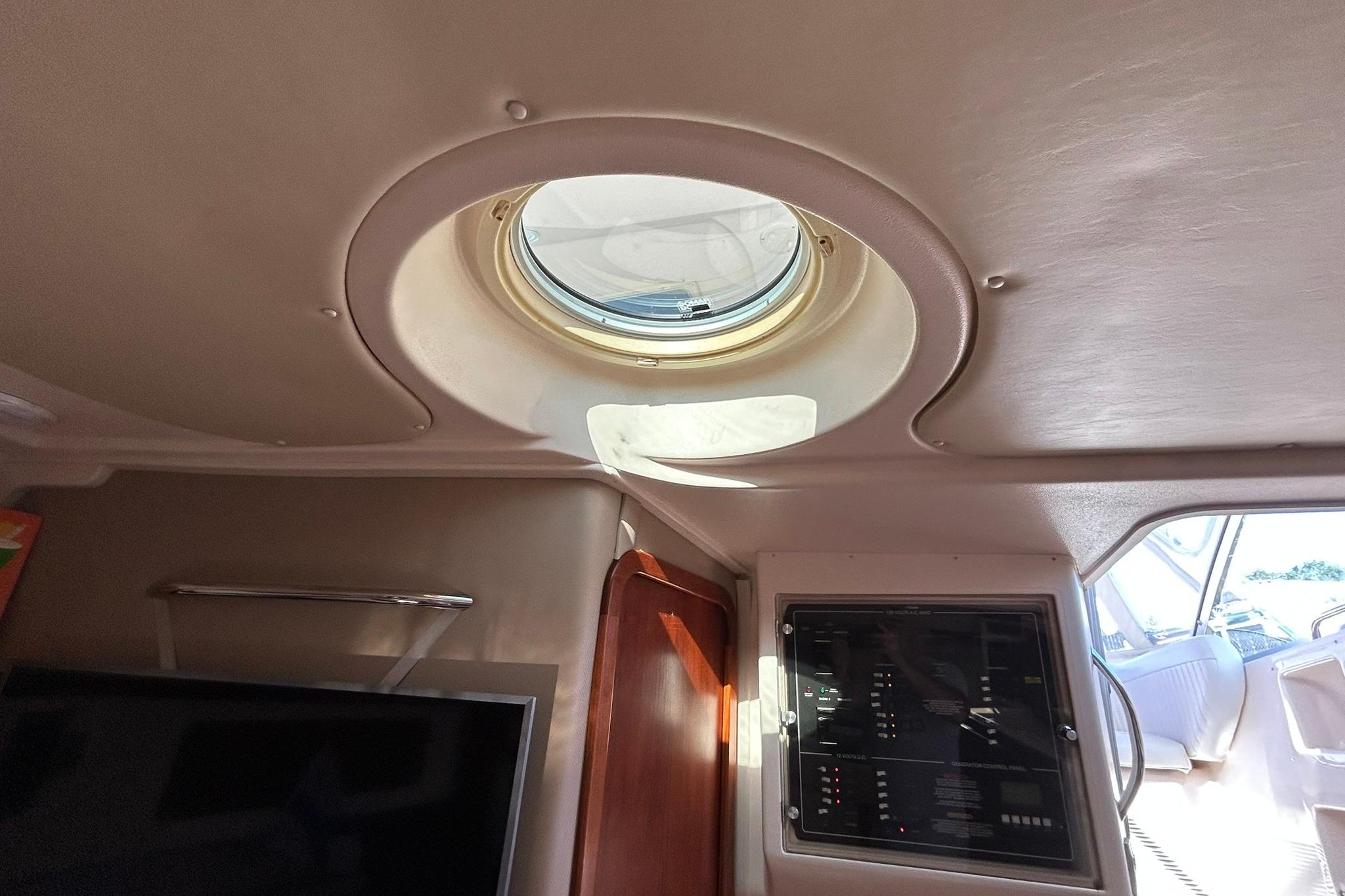 Interior view of 2007 Grady-White Express 360 boat, featuring a porthole and control panel.